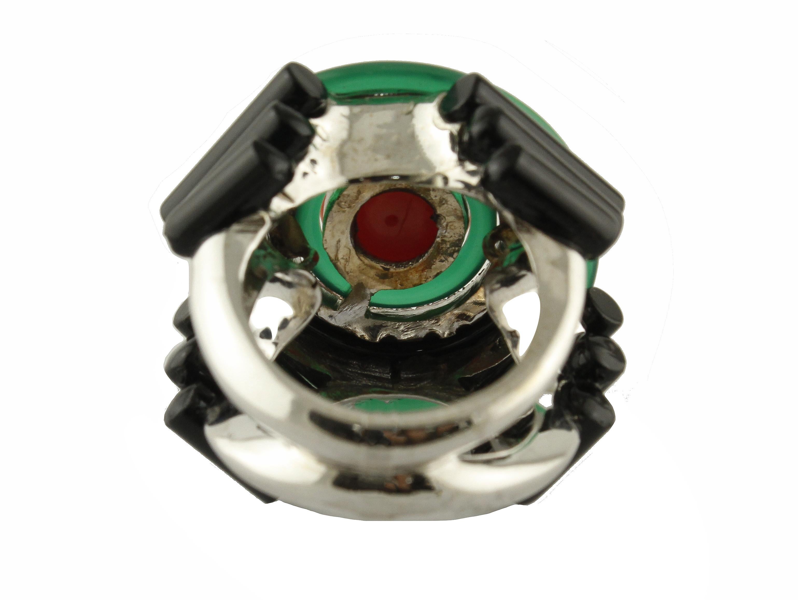 Amazing fashion ring in 14K white gold ring mounted with coral sphere in the center surrounded by diamonds crown, green agate hoop, onyx hoop and an other green agate hoop and finally onyx stick on the sides
Diamonds 0.50 ct 
Onyx, Green Agate 4.60