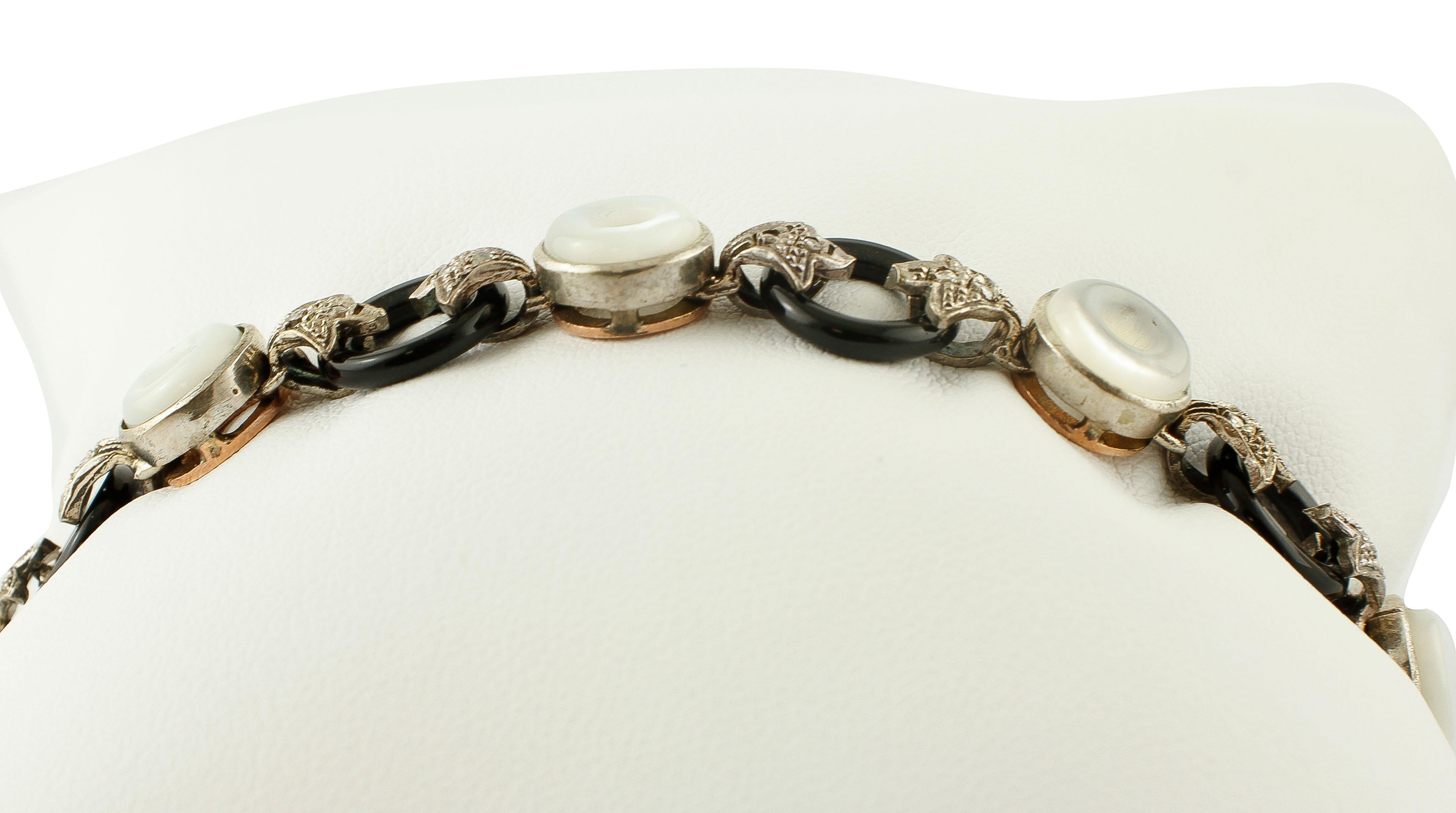 Beautiful retro bracelet in 9k rose gold and silver structure, formed by onyx ring and white hard stone rings which alternate along the bracelet. The black and white rings are linked together by silver details studded with diamonds. 
The origin of