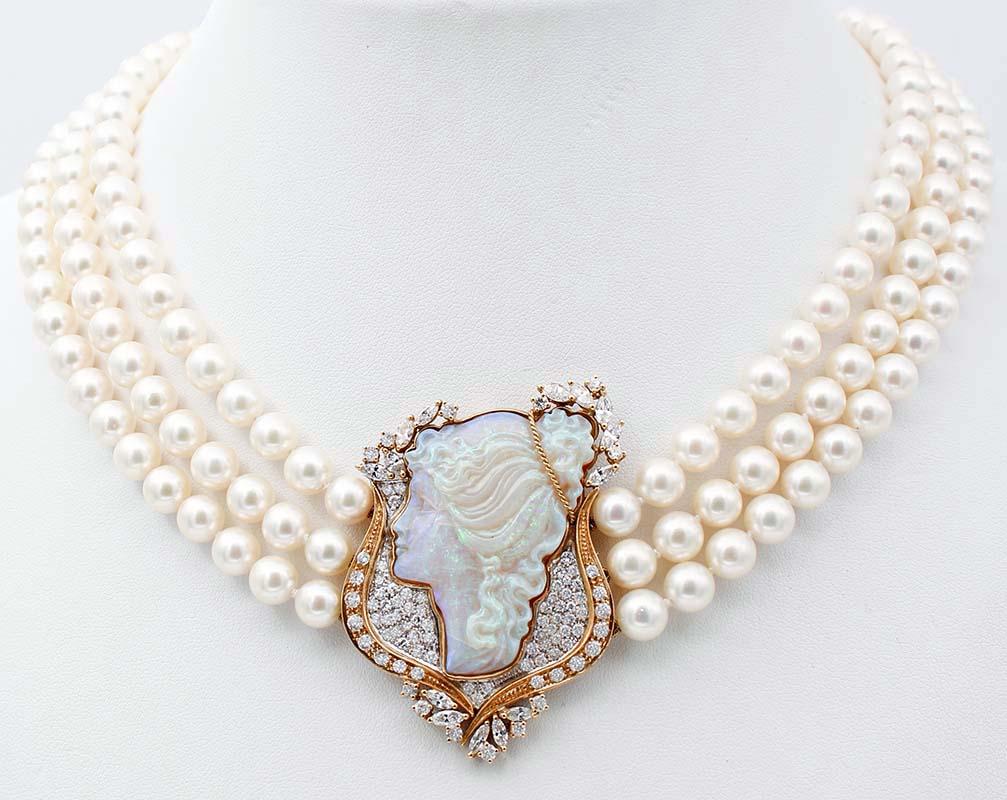 Marvelous one-of-a-kind beaded multi-strands pearl necklace in 18k yellow gold.  This necklace is formed by 3 strands of untreated Akoya pearls, which converge in a fabulous opal stone finely carved with a lady profile, enriched with yellow gold