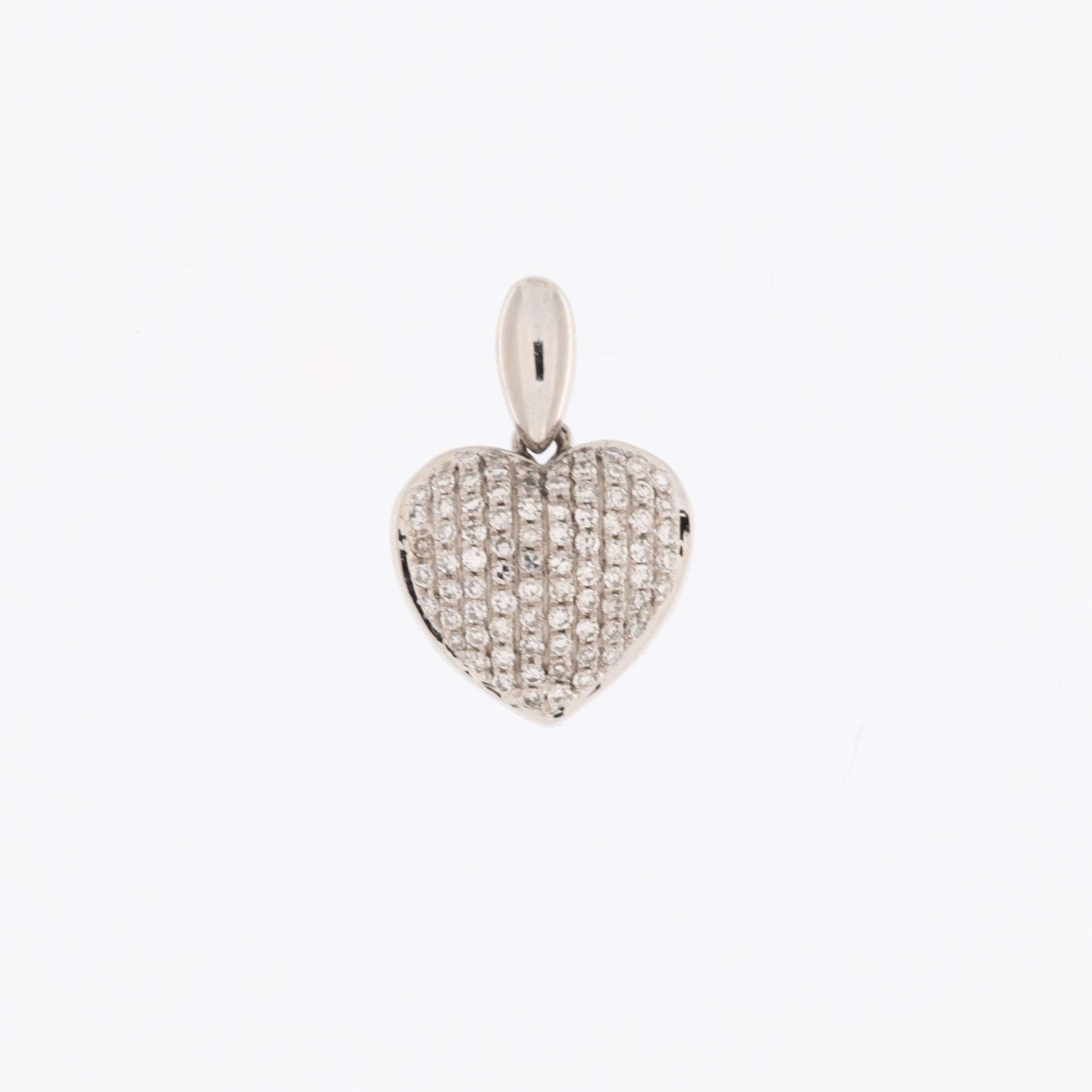 The Diamonds Pavé Heart Pendant in White Gold is a stunning emblem of grace and elegance. Crafted from 18-karat white gold, this pendant boasts a contemporary design adorned with dazzling brilliance.

The pendant features a cluster of brilliant-cut