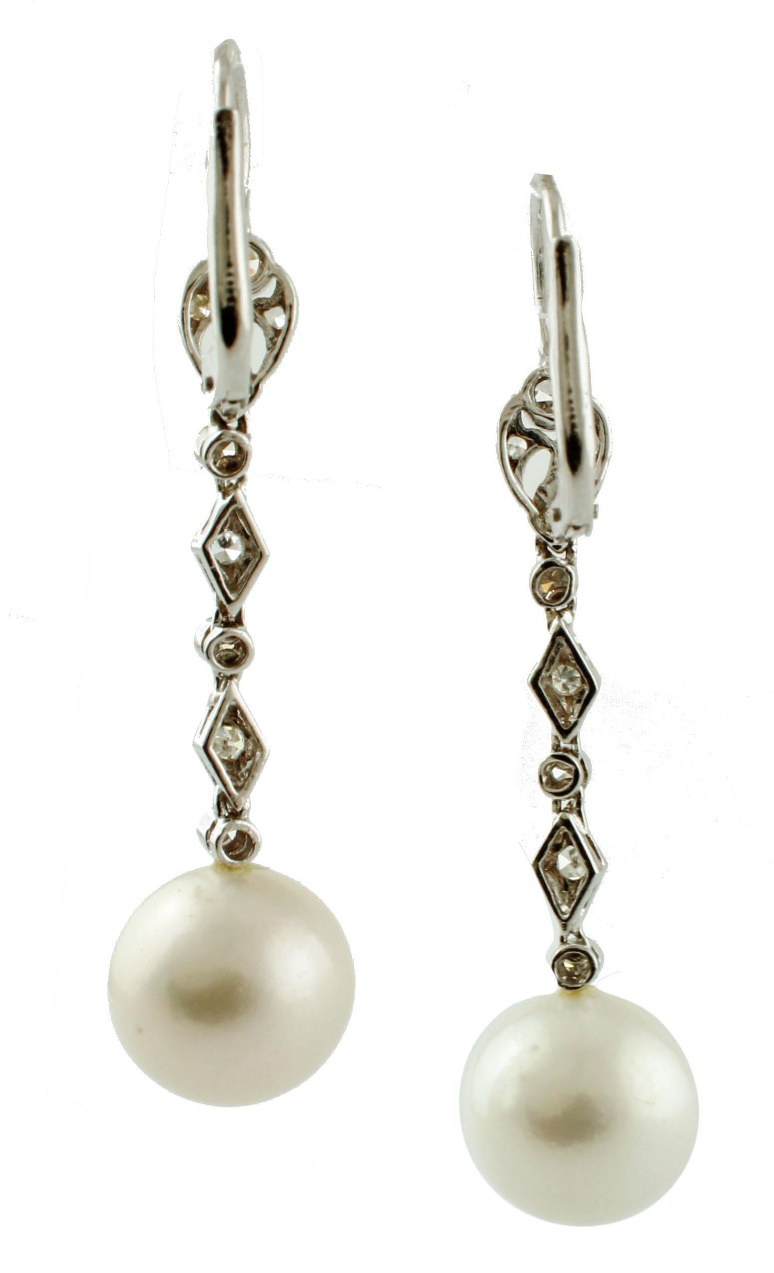 Beautiful dangle earrings in 14k white gold structure, mounted with south sea pearls as pendant and enriched with diamonds along the gold structure. 
These earrings are totally handmade by Italian master goldsmiths
Diamonds 0.51 ct
South sea pearls