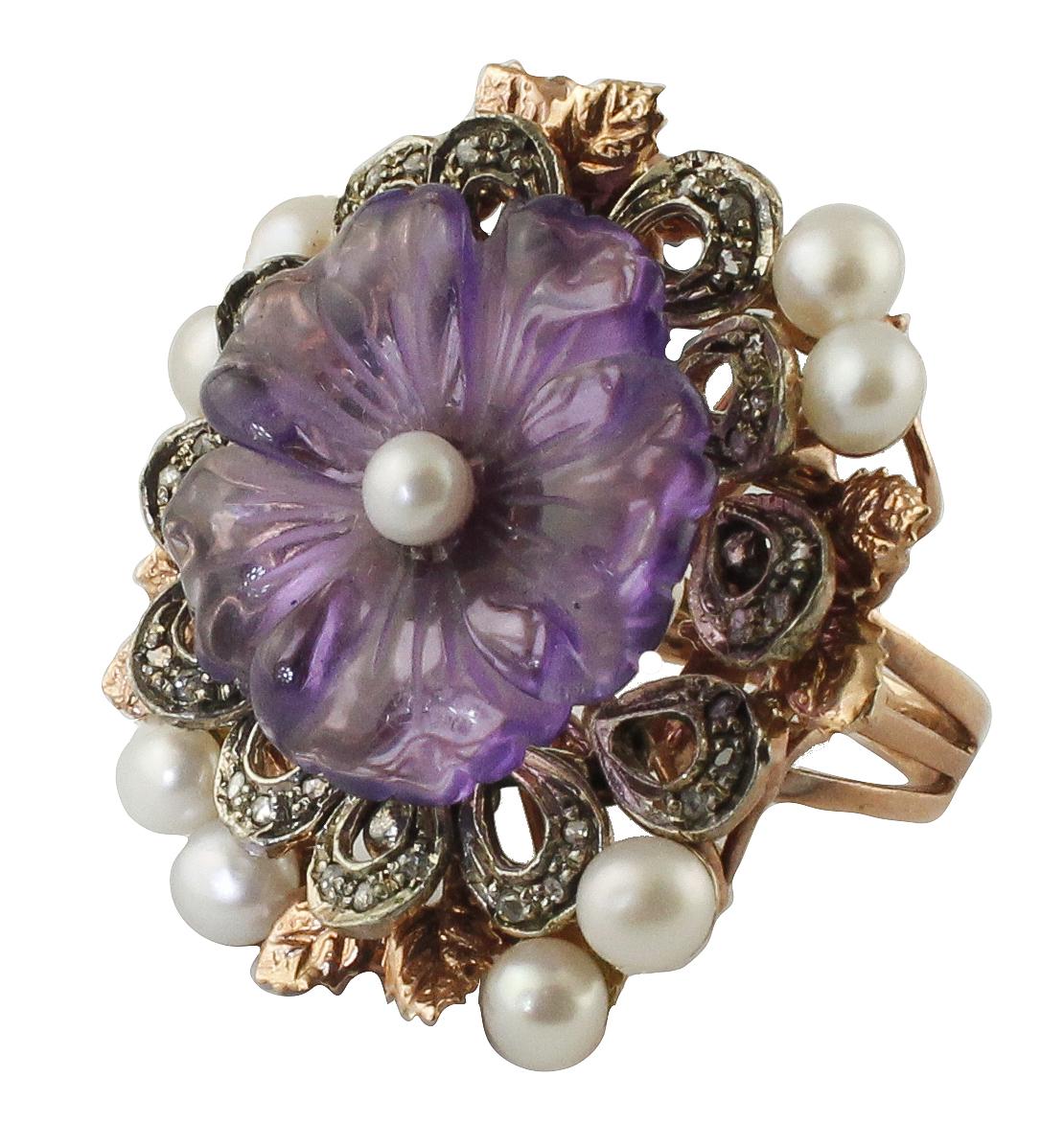 Delicate flower ring in 9k rose gold structure composed by amethyst flower with a pearl in the center, and surrounded by silver detailes studded by diamonds, rose gold leaves, and pearls.
Diamonds 0.28 ct
Amethyst Flower 2.00 g
Pearls 0.90 g
Total