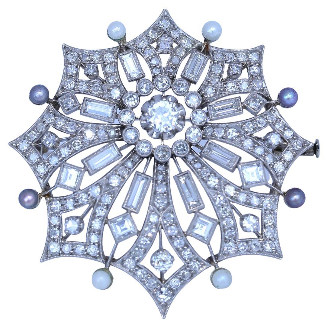 Superb Diamonds and Pearls brooch, 18 Karat White Gold. Tiny Pearls of Grey and White colours with a round-cut diamond in the middle. Superb craftsmanship of the jeweler makes it look like a snowflake, so delicate and yet so fine shining on the