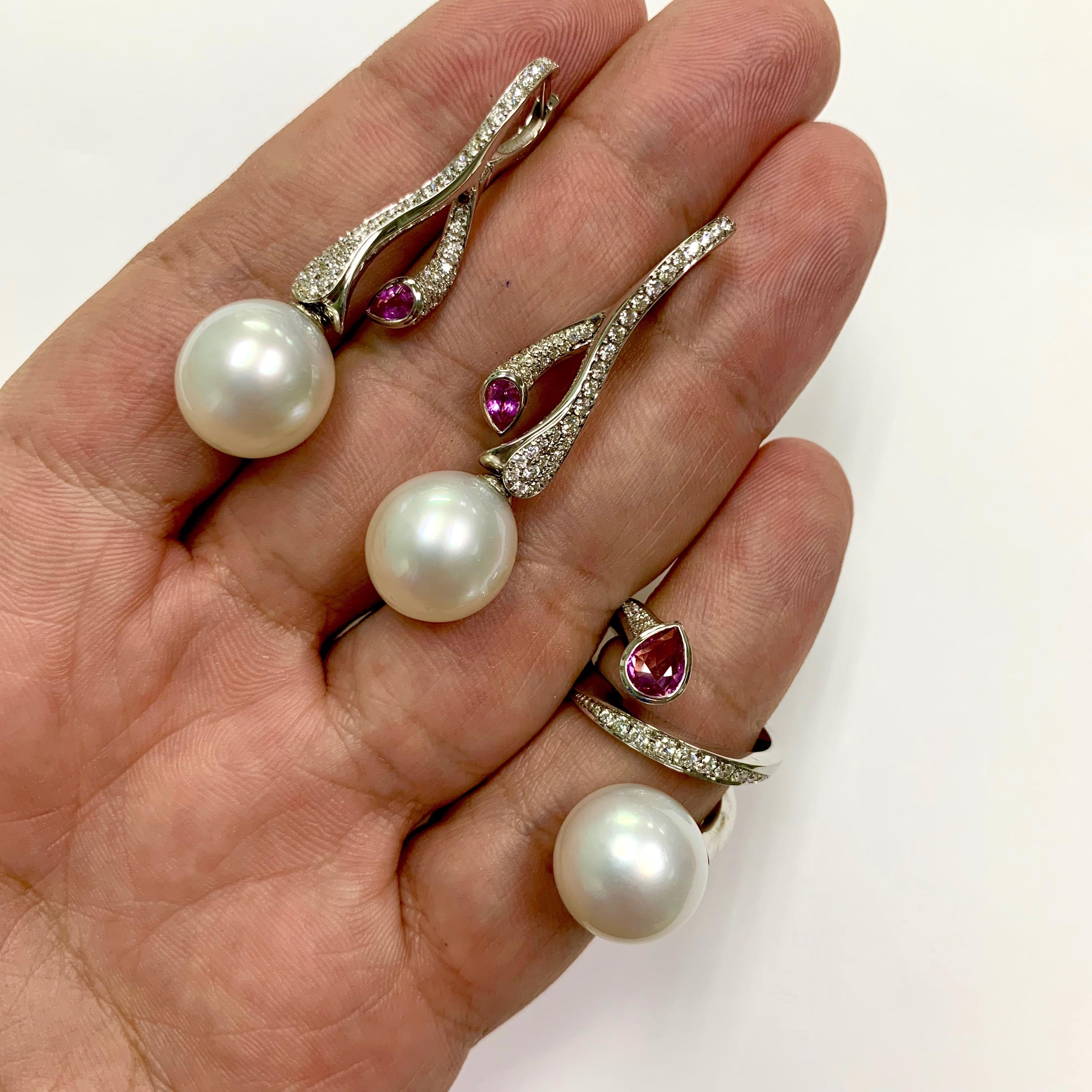 Diamonds Pink Sapphire South Sea Pearl 18 Karat White Gold Ring Earrings Suite
Ring is made in the shape of a spiral, symbolizing a water funnel, carrying it to the depth of the ocean, where a delightful South Sea Pearl 13-14 mm awaits us. Pink