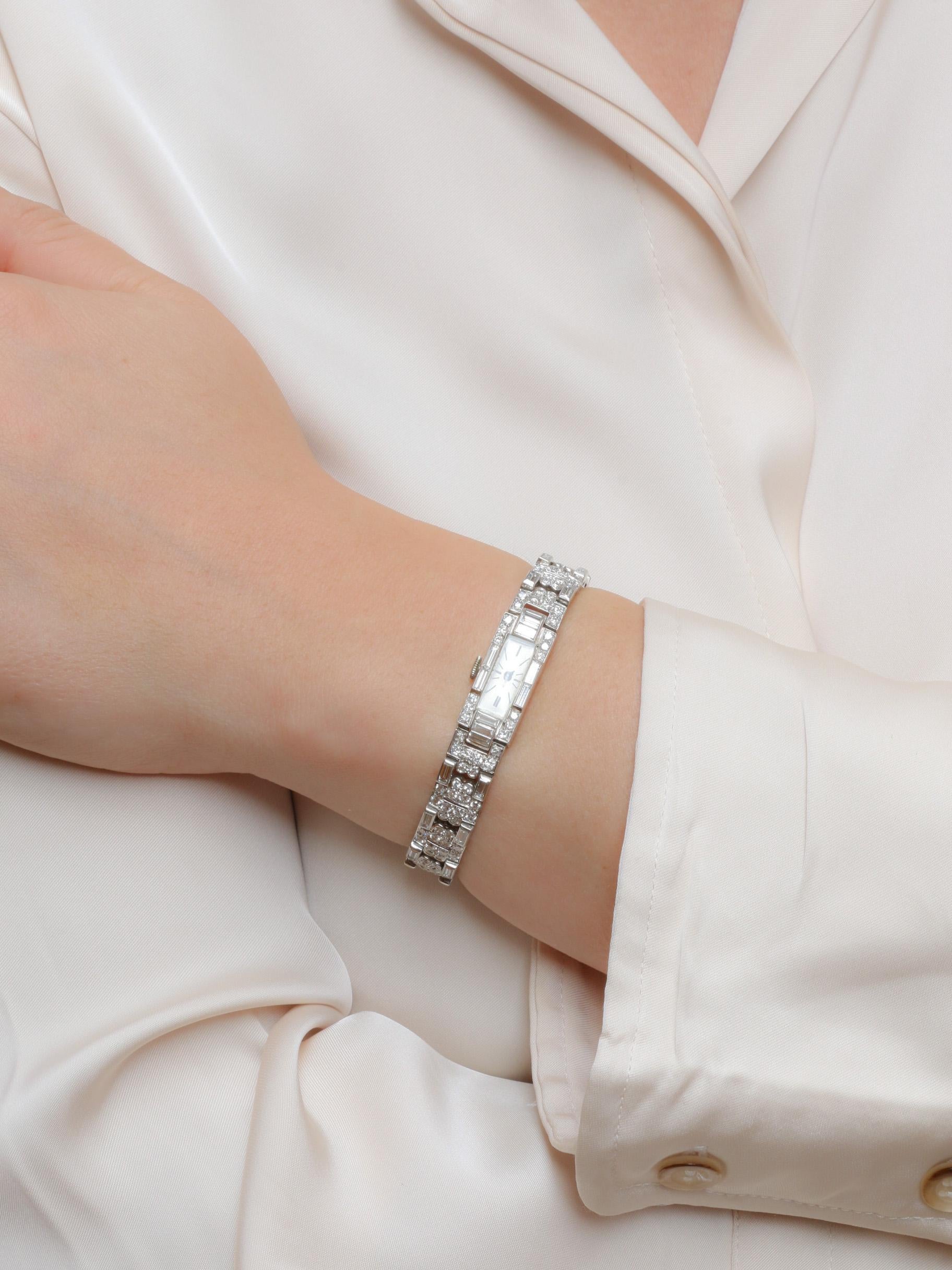 Art Deco watch in platinum & diamonds 11 carats

Art Deco watch in platinum and diamonds. The articulated bracelet is entirely set with diamonds, creating a geometric motif. It is composed of alternating links featuring four-leaf clovers and two