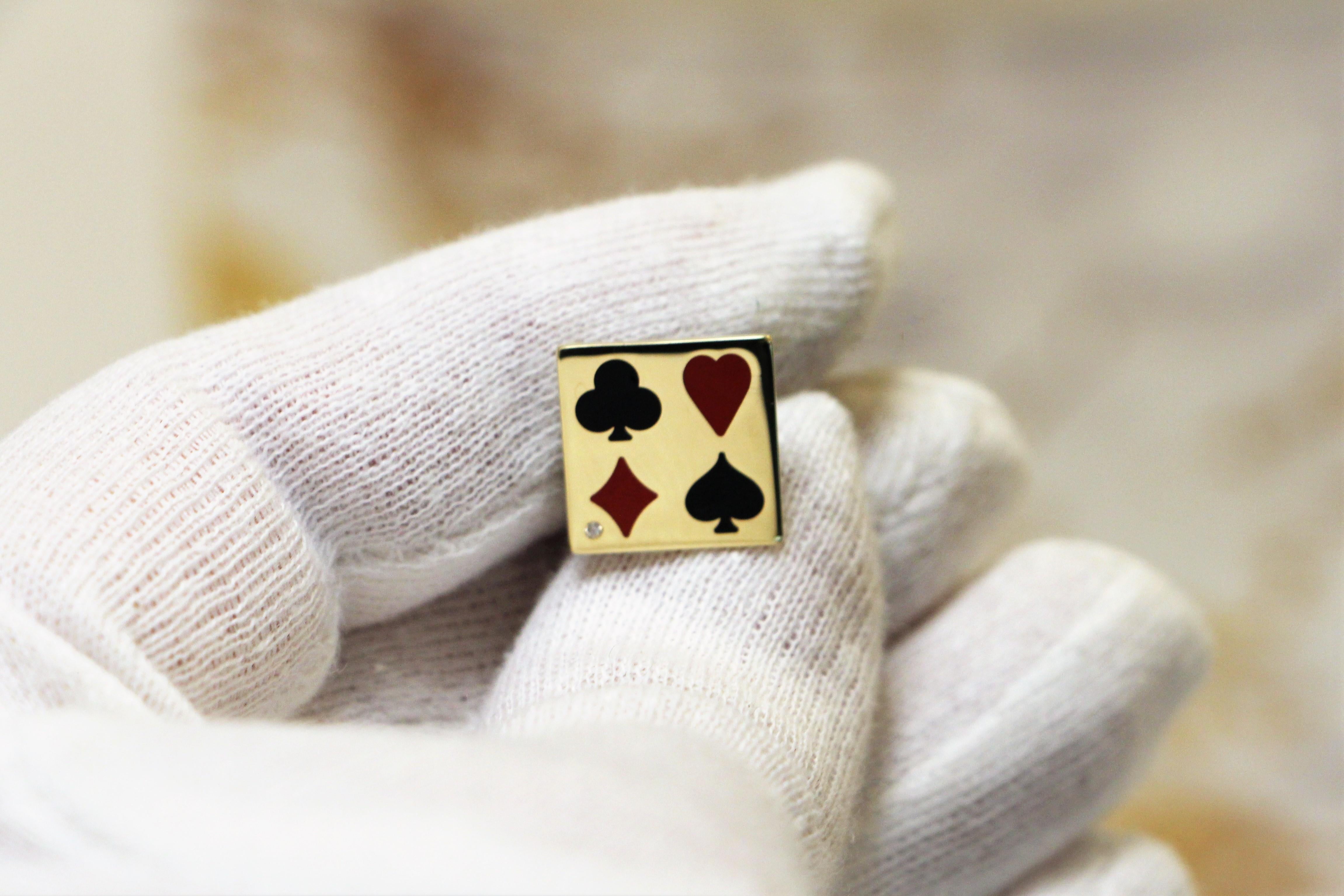 Square cufflinks handcrafted in 14Kt yellow gold, featuring the symbols of a playing card and a brilliant cut diamond. The two different colours of ceramic enamel -cerachrom- black and red, create a mesmerising play between light while the diamond