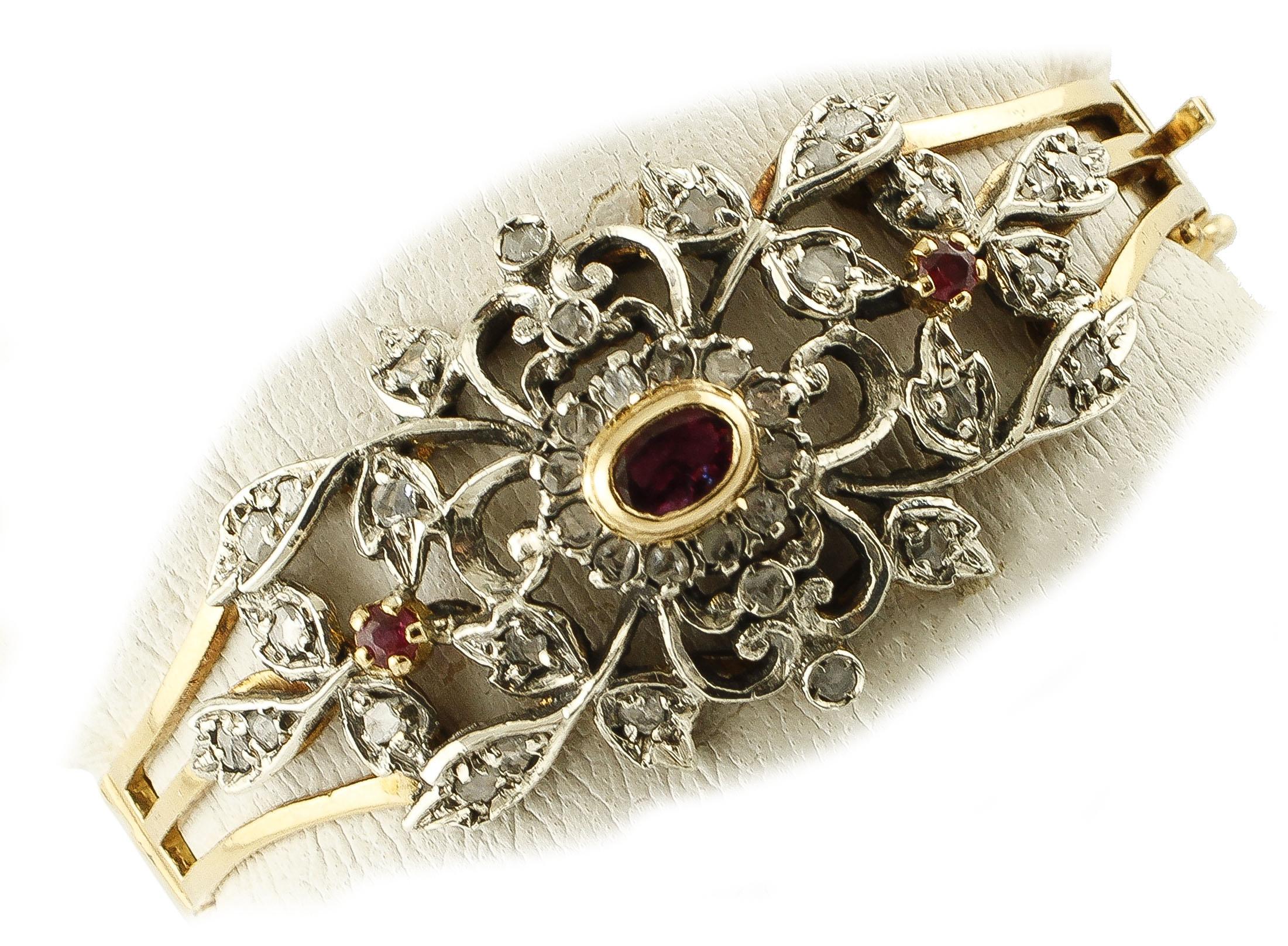 Vintage clamper bracelet in 18k yellow gold and silver, with flowery decorations in silver structure studded with diamonds and rubies.
The origin of this bracelet goes back to the 1950s, it was totally handmade by Italian master goldsmiths and it is