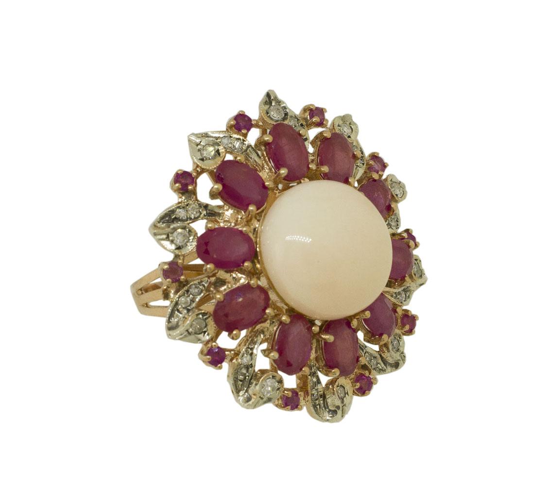 Gorgeous Flower theme fashion ring in 9K rose gold and silver structure composed by 2.40 g of angel skin pink coral surrounded by deep color rubies crown. It is embellished by leaves detailes studded by 0.39 ct of little diamonds and finally