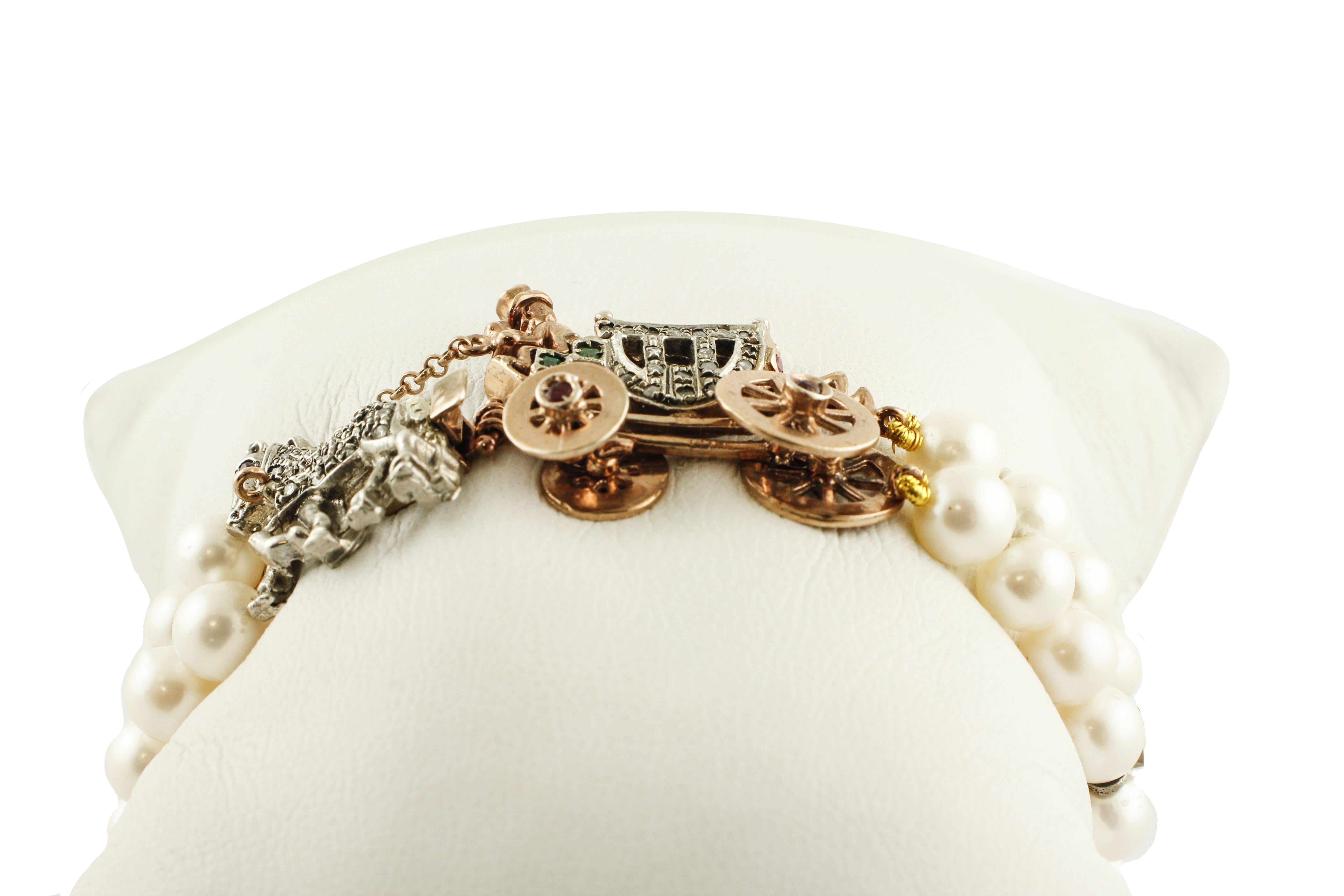 Unique beaded bracelet composed of two white pearls rows (17.30 g) connected with 4 9K rose gold and silver structure studded by rubies. It has a very special closure in 9K rose gold and silver, that representing a carriage with movable wheels and