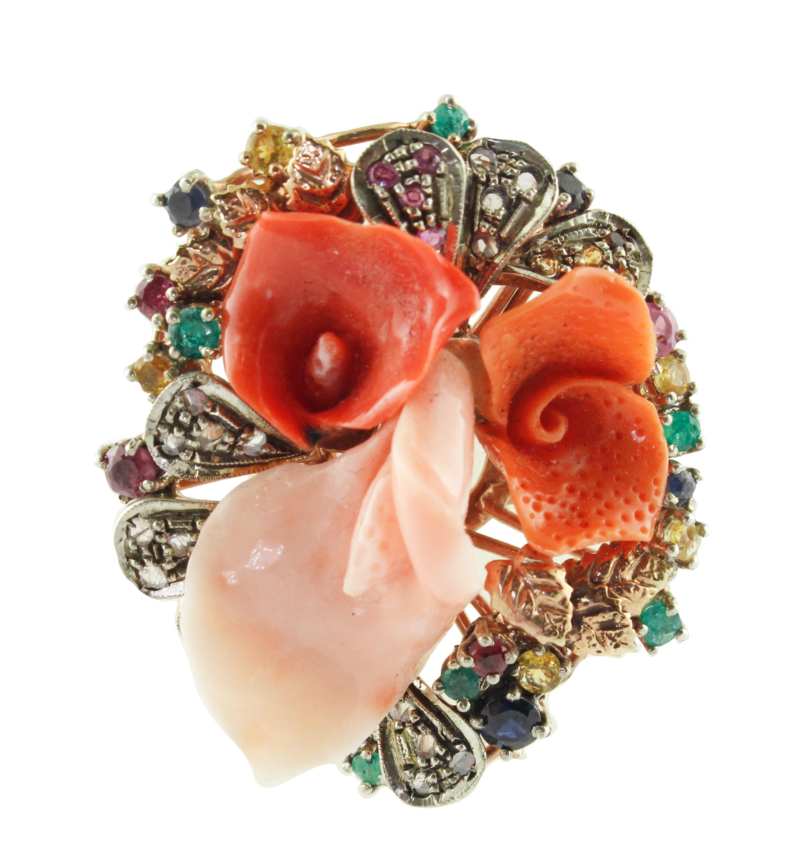 Fashion flower ring in 9K rose gold and silver structure composed by 3 coral petals in the center ( one pink, one orange, one red) and it is studded all around by diamonds, rubies, emeralds, blue sapphires, and yellow sapphires.
Diamonds 0.20 ct