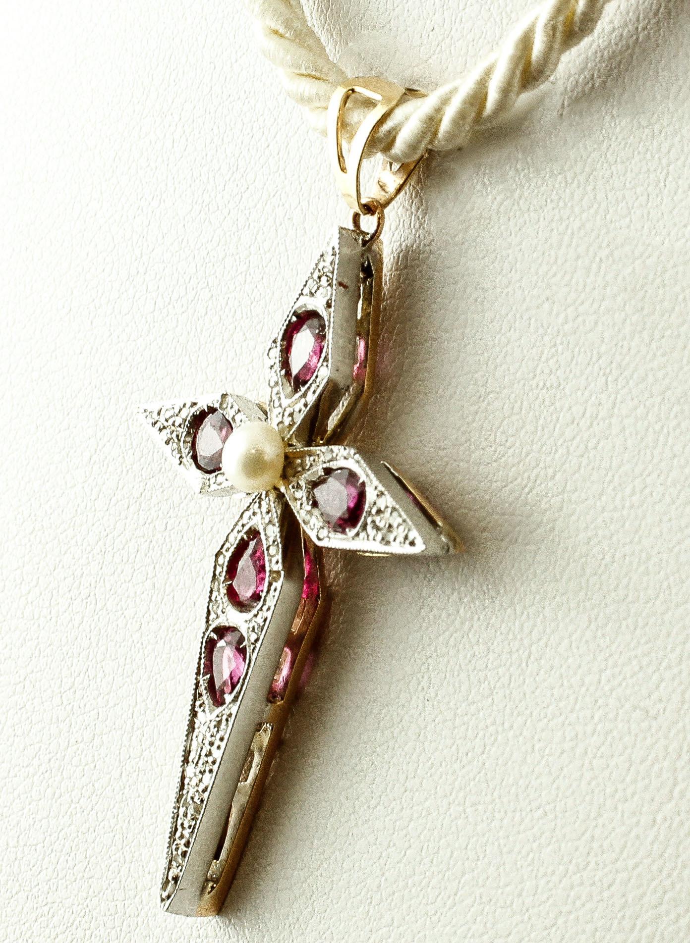 Beautiful retro cross pendant in 9k yellow gold and silver structure, setted with 5 intense rubies, a central little pearl, and little diamonds along all the cross surface. 
This cross is totally handmade by Italian master goldsmiths
Diamonds 0.17