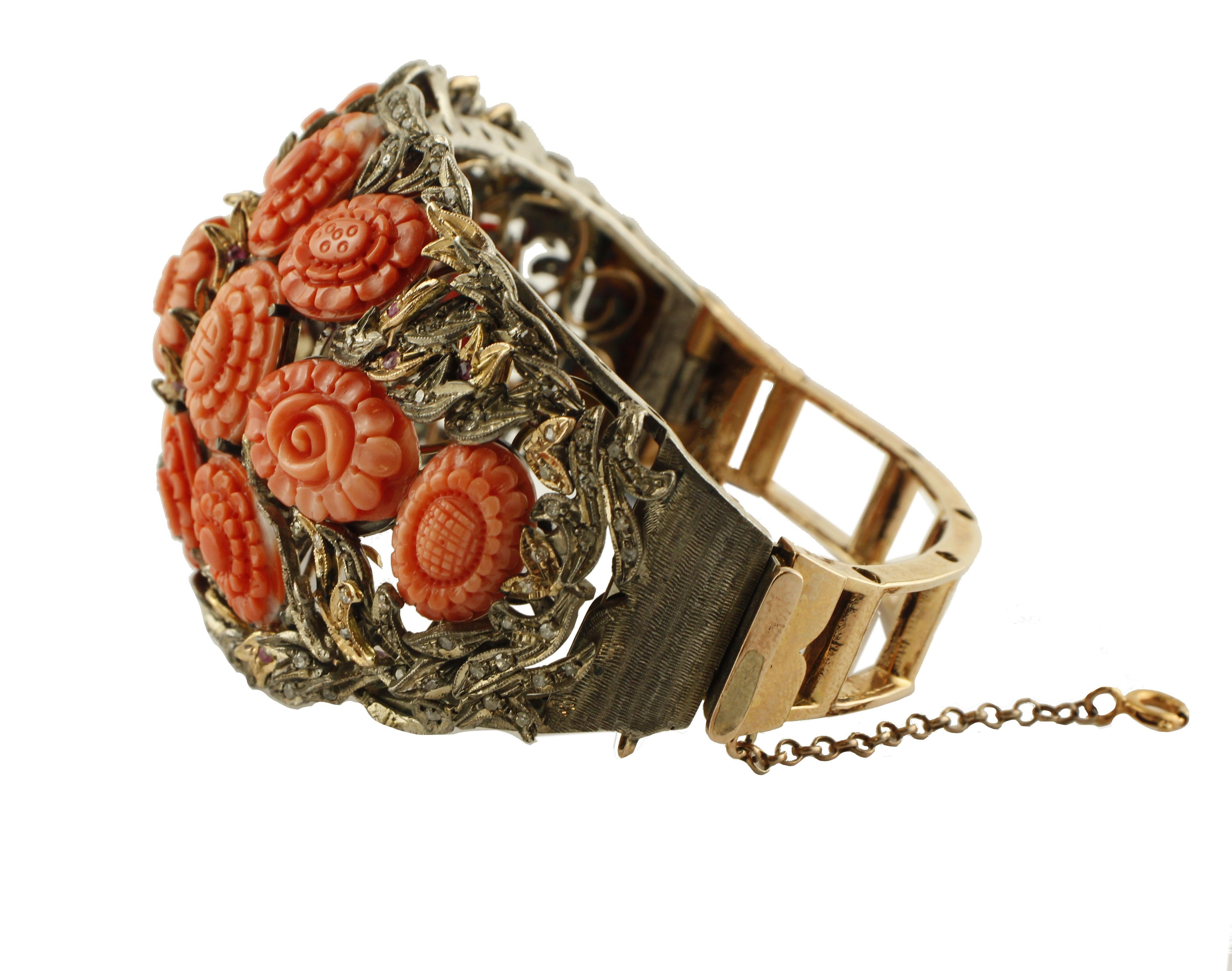 Gorgeous rigid retrò bracelet, realized in 9K rose gold and silver mounted with 9.80 g of red rubrum carved coral flowers  in the center and adorned with leaved detailes studded with 1.75 ct of little diamonds and 0.27 ct of little rubies.
Diamonds