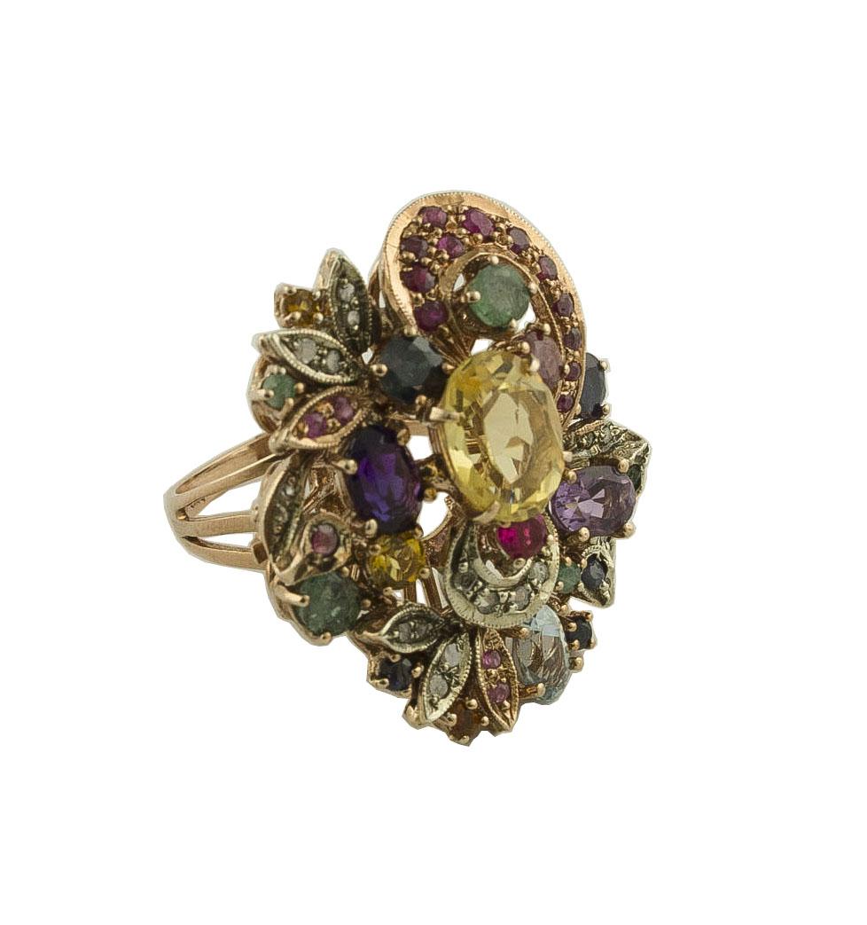 Fashion ring in 9K rose gold and silver mounted with diamonds, multi-color sapphires. rubies, emeralds, amethysts, yellow and light blue topazes
Diamonds 0.19 ct 
Multi-color Sapphires, Rubies, Emeralds 3.02 ct
Yellow, Light Blue Topazes, Amethysts