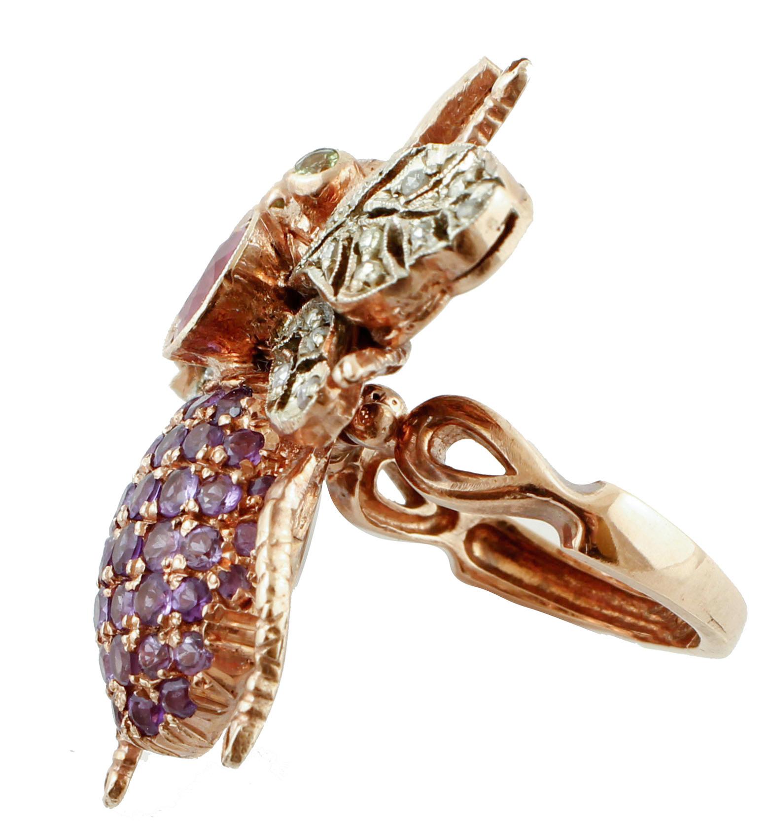 Unique retrò fashion ring realized with fly movable shape in 9K rose gold and silver structure. It has 2 peridots as eyes, and 1.93 ct of ruby on the neck, it is studded with amethysts on the body and with 0.44 ct of little diamonds on the