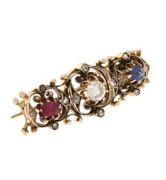 Broche en or jaune 14 carats diamants rubis saphir