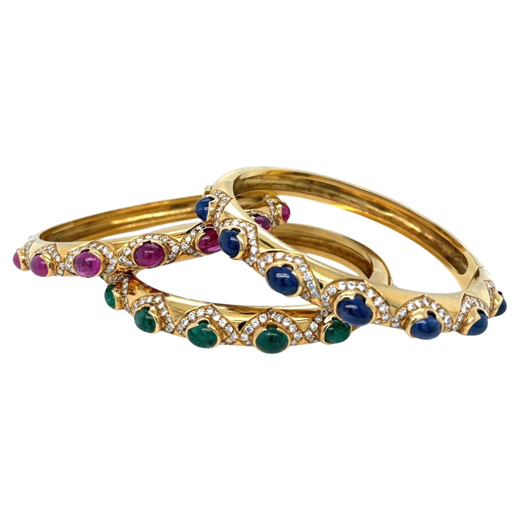 Gorgeus trio of bracelets in 18 kt yellow gold, set with Natural sapphires, rubies, emeralds and diamonds. Made around the 80s by the manufacturer Arcese, whose trademark 