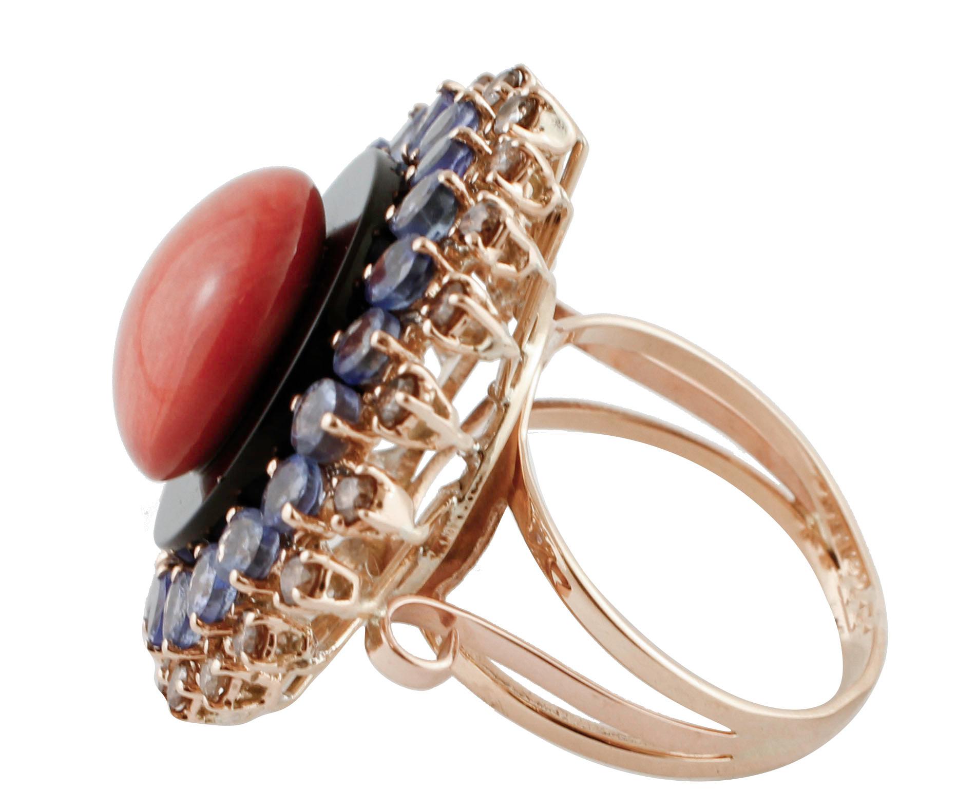 Gorgeous cocktail/fashion retrò ring realized with very special design in 14K rose gold mounted with 1.6 gr of red coral button in the center placed on  1.4 gr of onyx disk and embellished with 3.94 ct of tanzanite crown and 0.95 ct of diamonds