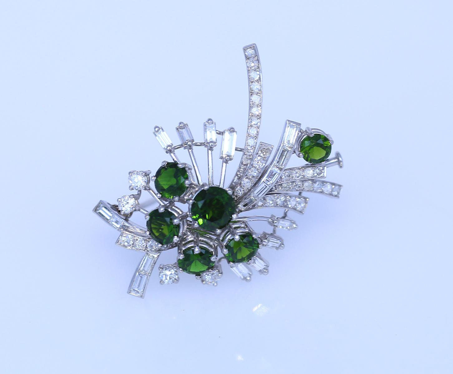 Fine Diamonds and Tourmalines Platinum Brooch. 

A dazzling contrast between the fine shiny Diamonds of different shapes and cuts and the magnificent green colour of the round-cut Tourmalines. A brooch worth of a fine jewelry collection yet the one