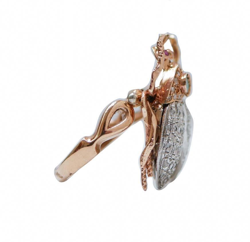 Fashion retrò ring 9 kt rose gold and silver structure mounted with two rubies as eyes and one emerald on the neck. All the neck and the wings are studded with diamonds. In addition, the rest of the body is studded with tsavorite. The stem of the