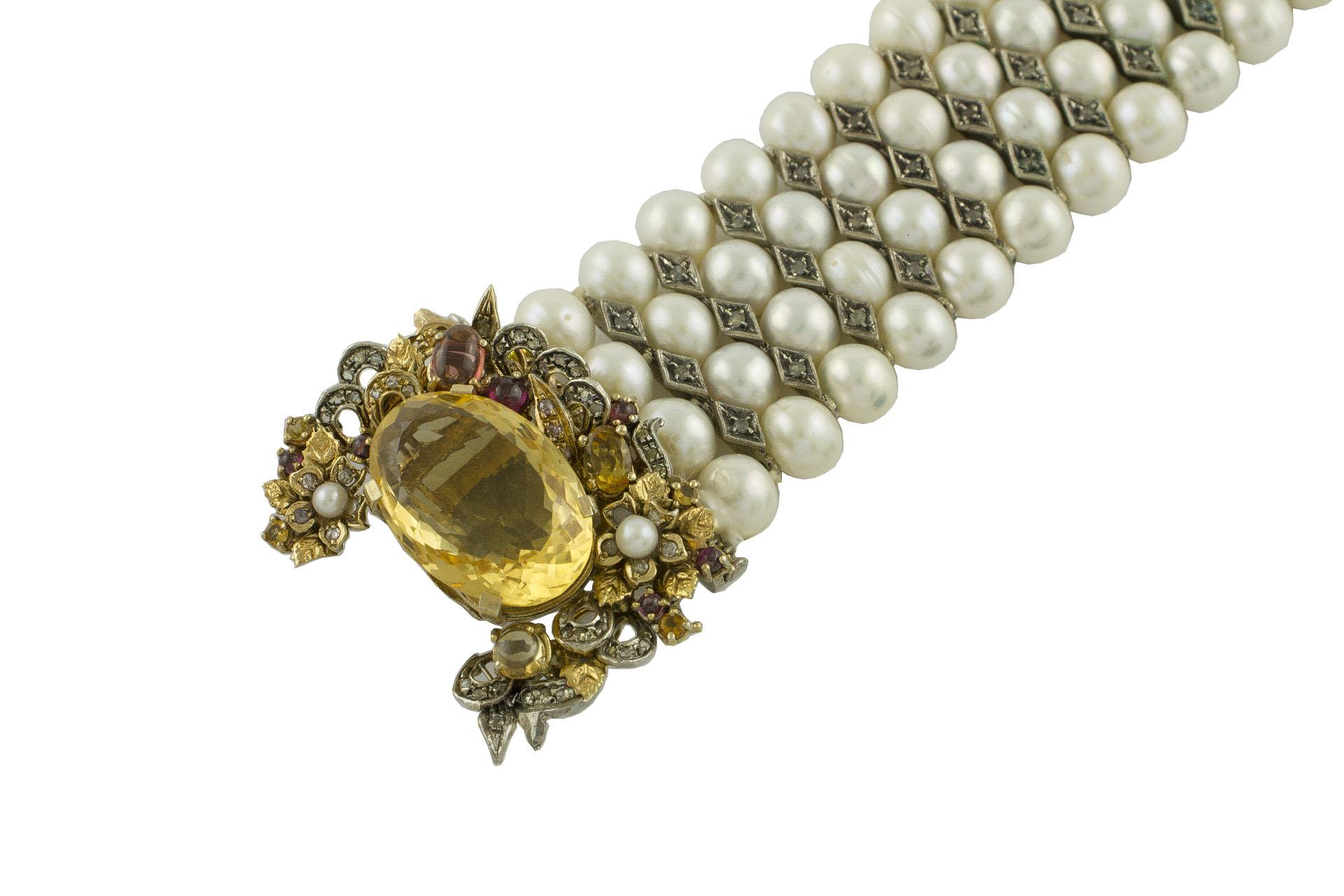Amazing Beaded bracelet composed of 4 glossy white pearls rows with rose cut diamonds rows in the middle, adorned with gorgeous closure in 9K rose gold and silver composed by big yellow topaz in the center and embellished all around by flowers and