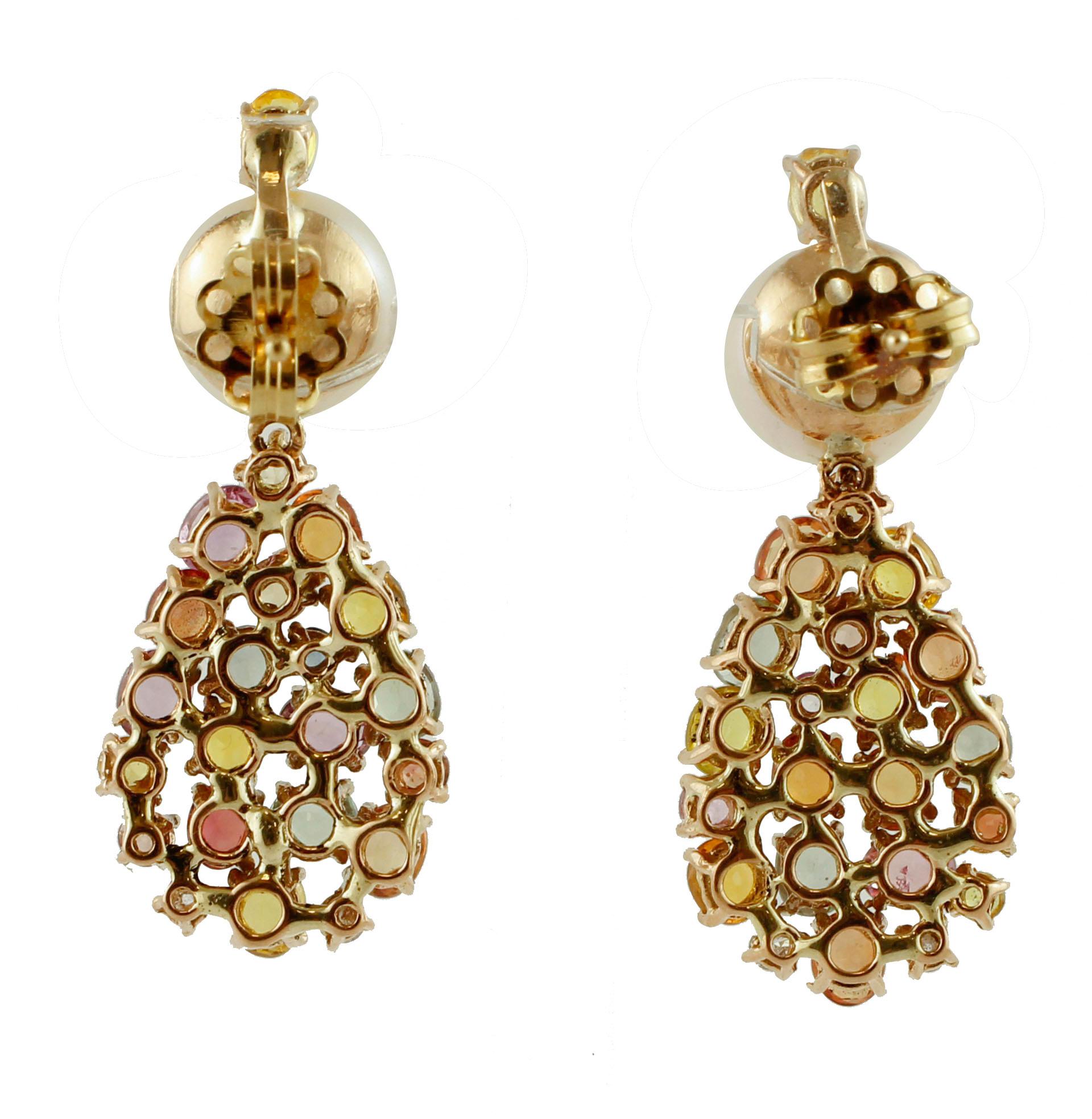 Gorgeous earrings in 14 kt rose gold structure mounted, at the top, with a white pearl and, over of it, a sapphire. The lower drop structure is studded with diamonds and multicolor sapphires.
These earrings are totally handmade by Italian master