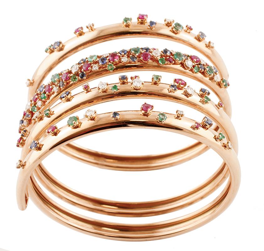 Retro spiral bangle bracelet realized in 18 kt yellow gold structure, set with spots of beautiful diamonds, rubies, emeralds, and sapphires.
This bracelet is totally handmade by italian master goldsmiths.
Diamonds 1.44 ct, Round Cut, F Color, VS