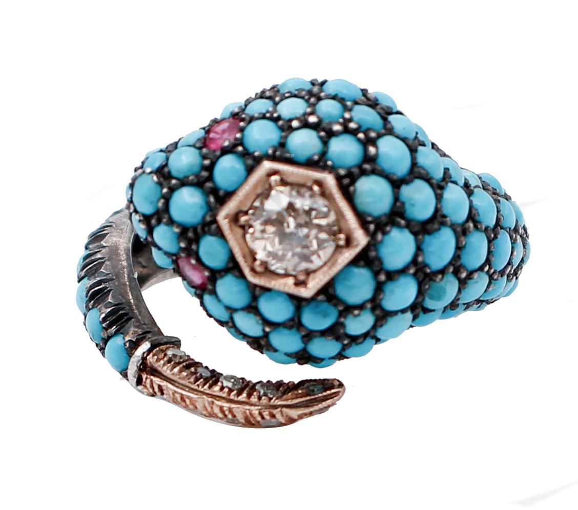 A particular snake-shaped ring in 9kt rose gold and silver structure, studded with turquoise on the body, two ruby as eyes and a diamond on the head and diamonds on the tail. 
This ring was totally handmade by Italian master goldsmiths and it is in