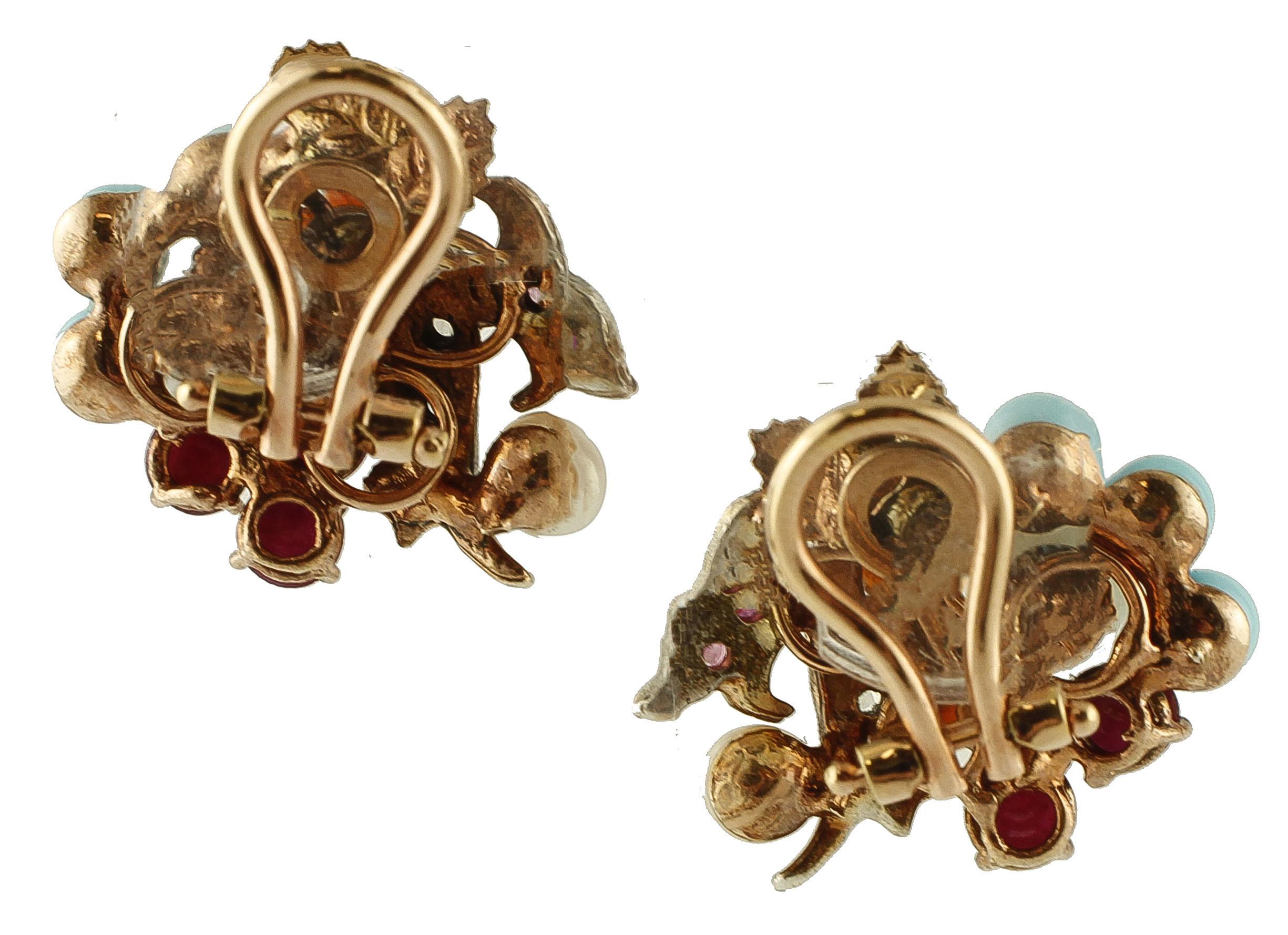 Beautiful pair of clip-on earrings in 9k rose gold and silver structure with flowery motif, realized with little flowers of mother-of-pearl and carnelian, plus adornments of turquoises, rubies, little pearls and silver leaves studded with diamonds