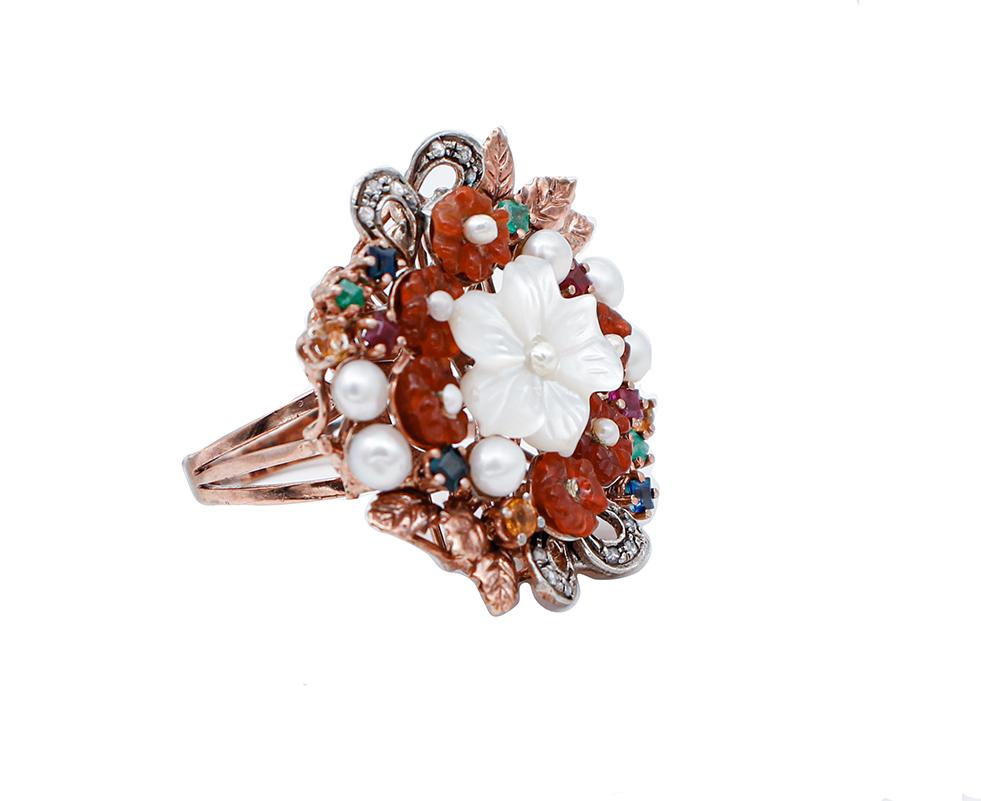 Beautiful retrò ring in 9 karat rose gold and silver structure mounted with flower shape white stone in the central part, surrounded by flowers shape stones, emeralds, rubies,sapphires and pearls.
This ring was totally handmade by Italian master