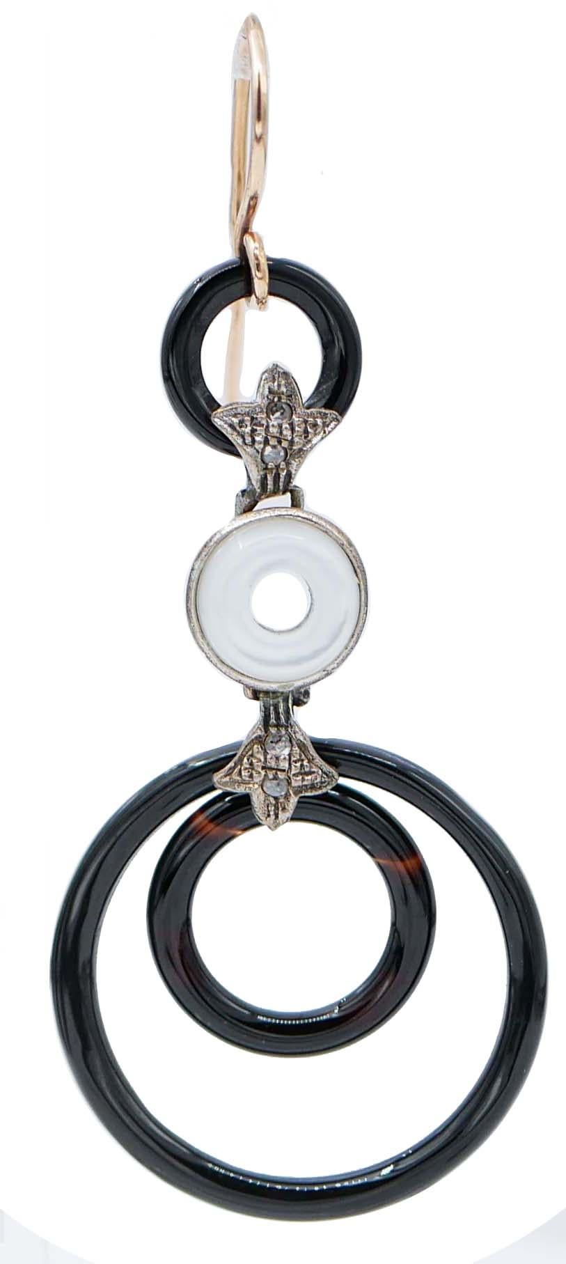 Gorgeous dangle earrings in 9 kt rose gold and silver structure mounted with a hoop of onyx in the upper part; in the middle, a white stones between diamonds and two hoops of onyx in the final part.
These earrings were totally handmade by Italian