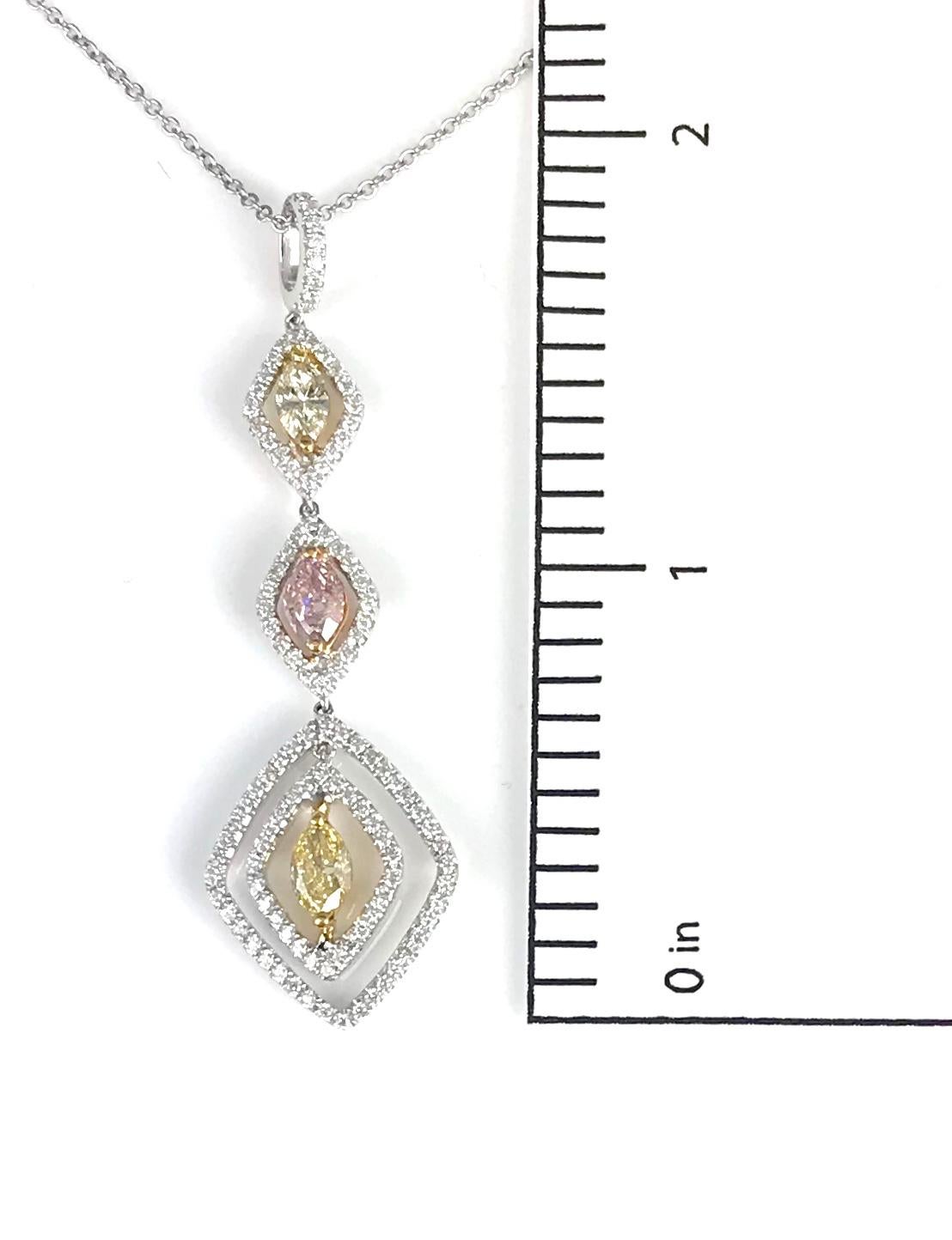 This three tier drop pendant features three marquise cut diamonds in pink, and yellow, each inside a frame of round white diamonds. Additional diamonds on the bail bring the total carat weight to 1.27 carats.

Pink Marquise cut diamond, 0.37