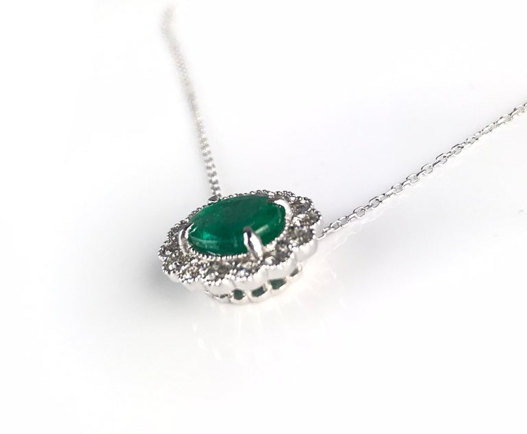 This beautiful pendant has a 1.37 carat oval cut emerald center, surrounded by a 0.42 carat halo of round white diamonds. Intricate milgrain work in the 18k White Gold setting bring out the old world classic charm of this piece.

Emerald: 8x6mm oval