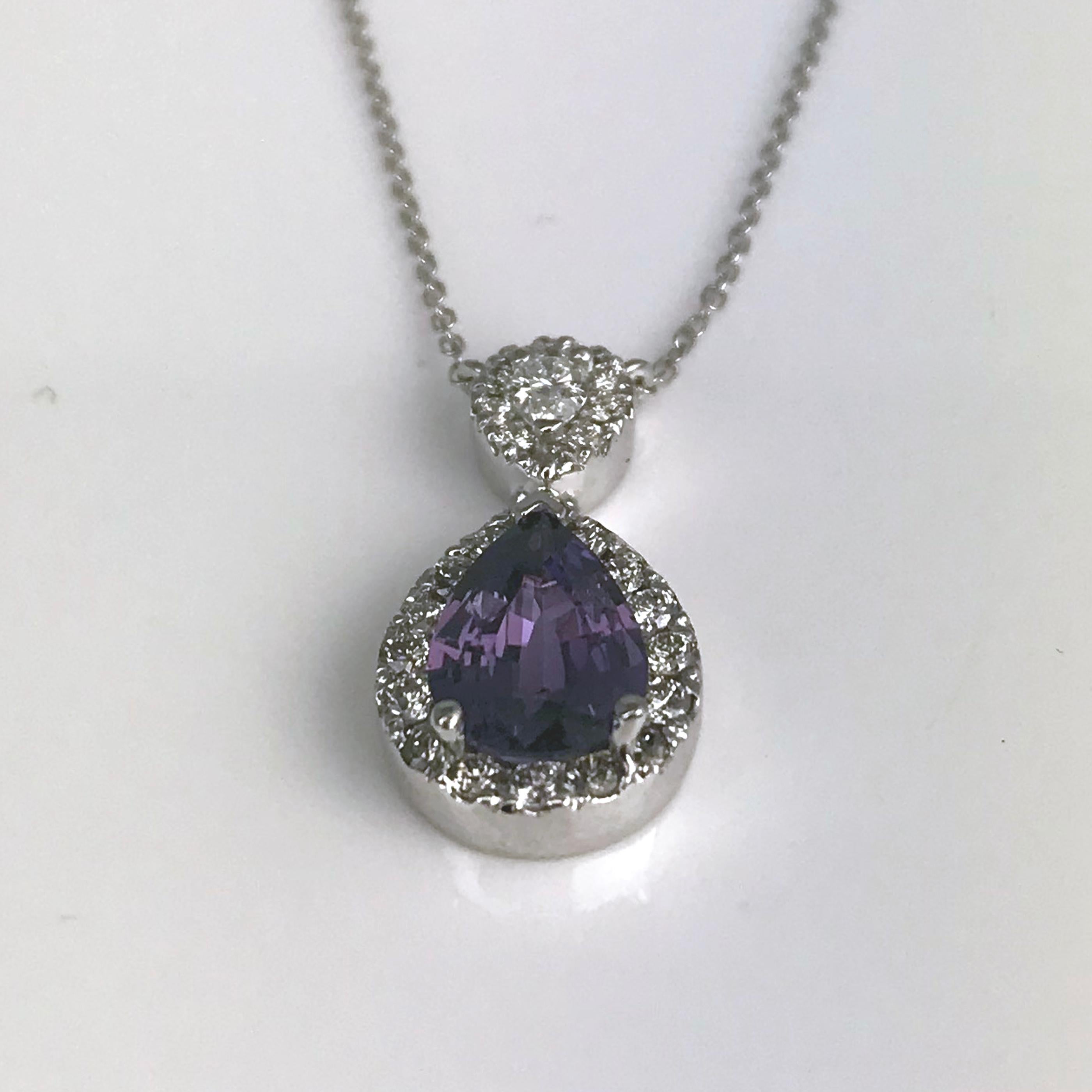 This pendant has a 1.49 carat pear shape Lavender Sapphire center, surrounded by a halo of round white diamonds. Another pear shape diamond decorates the bail, also in a halo of round diamonds. Total diamond weight 0.42 carats.

Sapphire: 1.49 carat