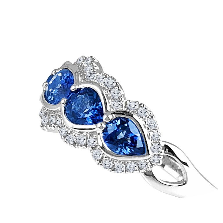 (DiamondTown) This gorgeous ring features five blue sapphires, total 1.78 carats. There are four pear shape stones, total 1.27 carats, and a center oval cut sapphire of 0.51 carats. The sapphires are nestled among 0.29 carats of white