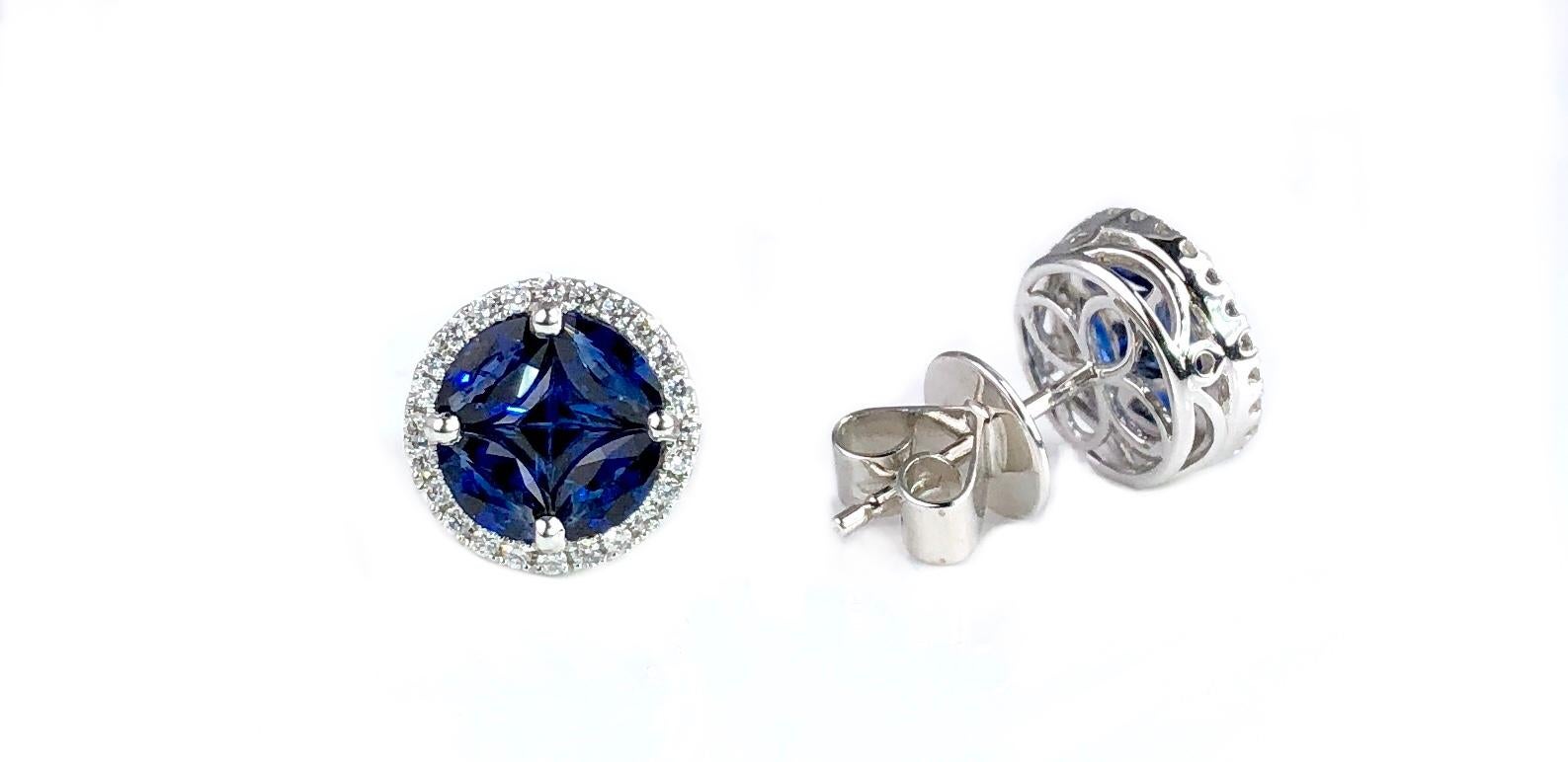 (DiamondTown) These round stud earrings feature a cluster center of blue sapphires (total weight 1.79 carats), surrounded by a halo of round white diamonds (total weight 0.22 carats).

Set in 18k White Gold

A matching bracelet and pendant are