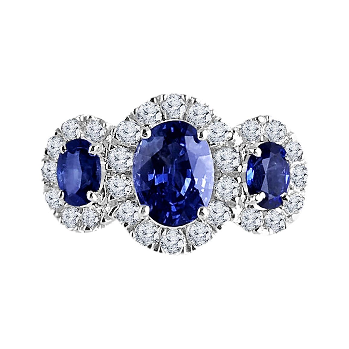 This ring is a true testament to elegance and sophistication. Crafted to perfection, it features not just one, but three stunning oval-cut sapphires totaling 2.45 carats. Each sapphire is beautifully ensconced within its own halo of dazzling round