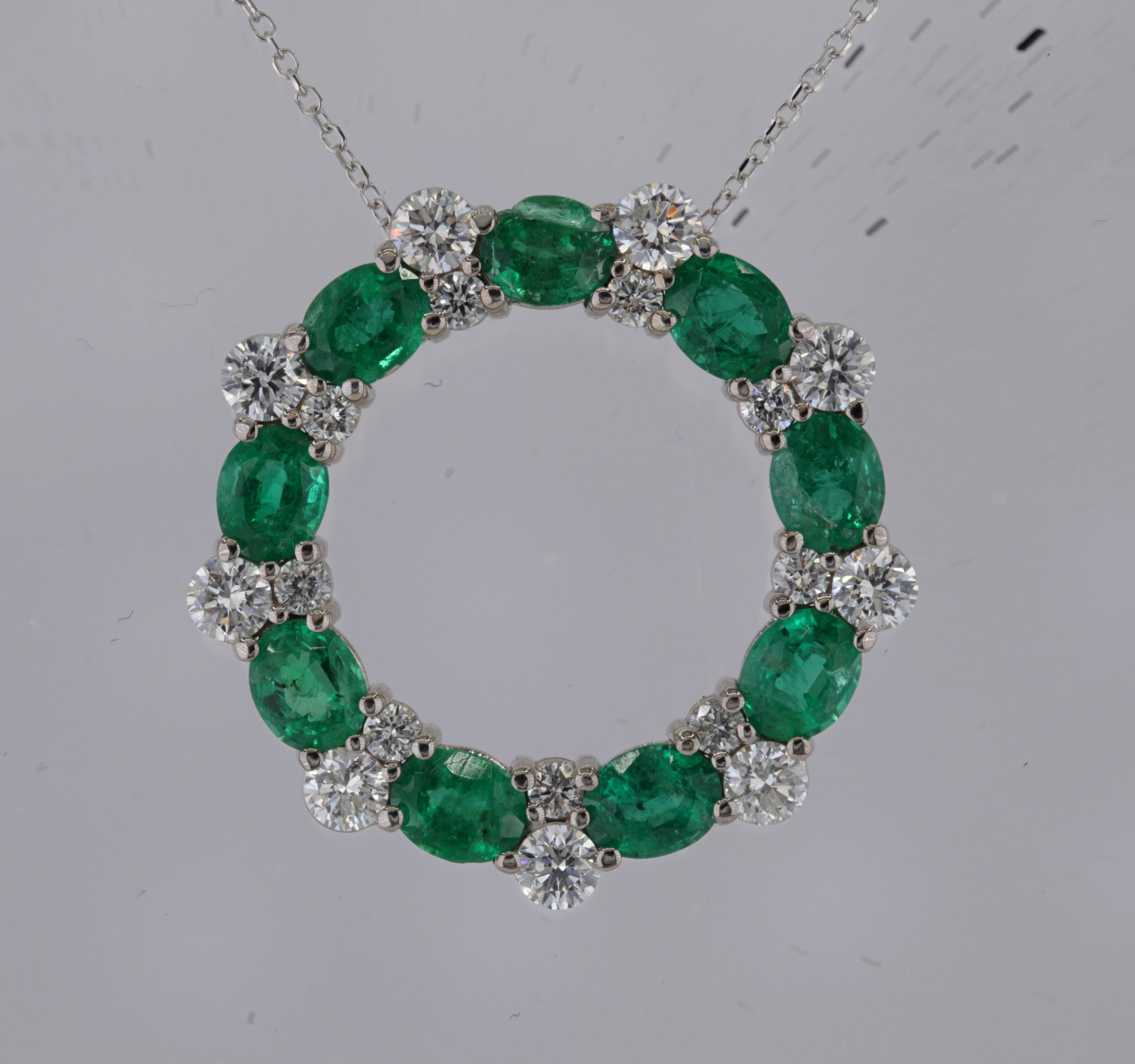 Adorn yourself with the enchanting allure of nature's vibrant hues and sparkling brilliance. Our circle pendant, a true masterpiece, features nine exquisite oval-cut emeralds, totaling 2.75 carats. Each emerald, measuring 5x4mm, captures the rich