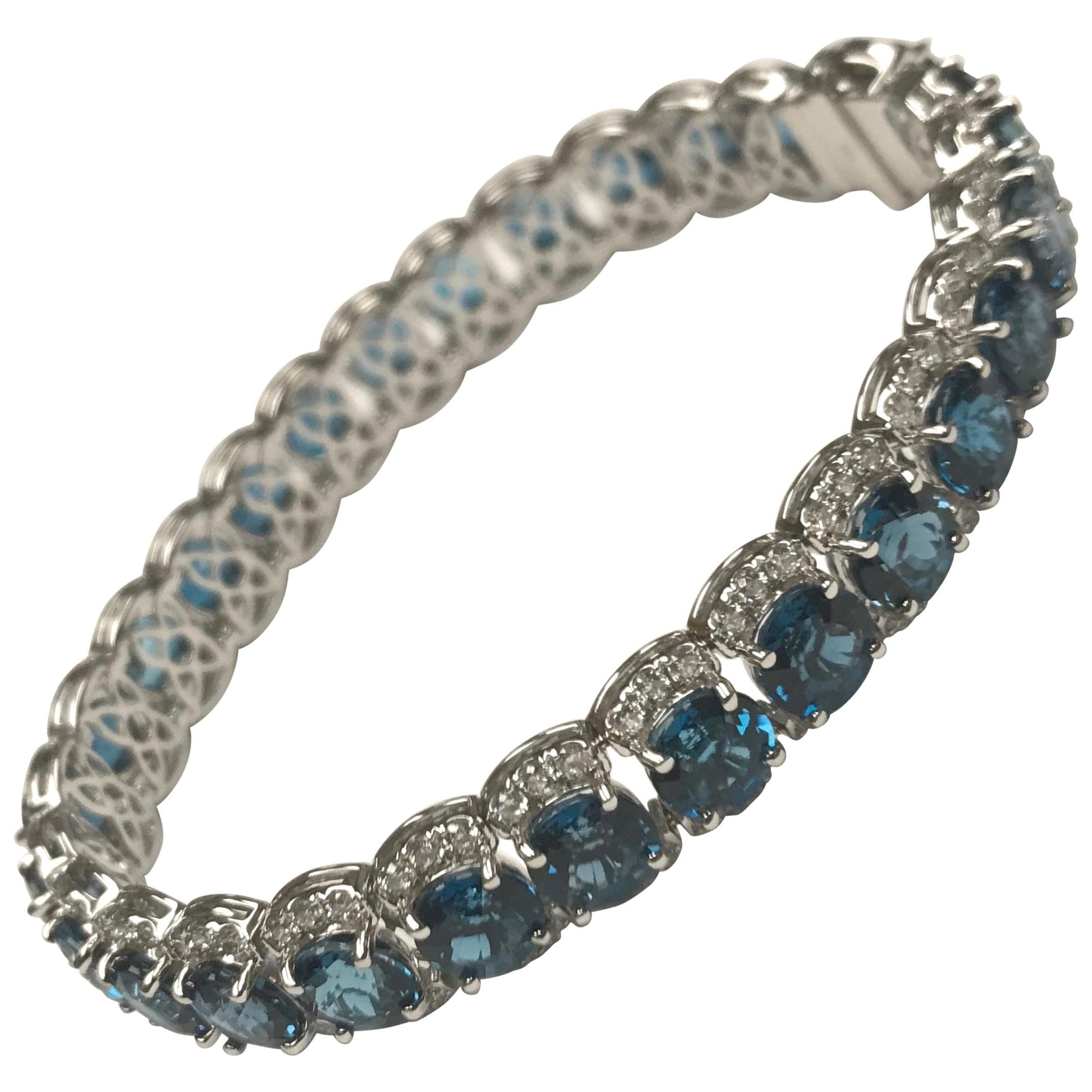 This bracelet features 28 Step Cut Blue Topaz between 3.10 carats round white diamonds.
The bracelet measures 7