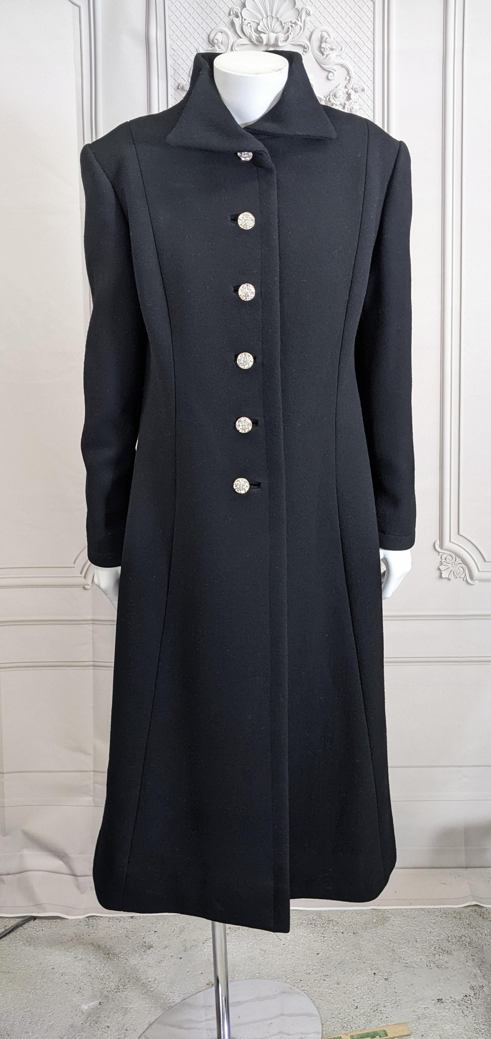 Elegant Diamonte Buttoned Black Evening Coat from the 1970's. Heavy black wool with Swarovski crystal decorated buttons down front and back as well. 
Extended shoulders, fitted torso and slight flare in skirt. Custom made. 
1970's USA. Small size.