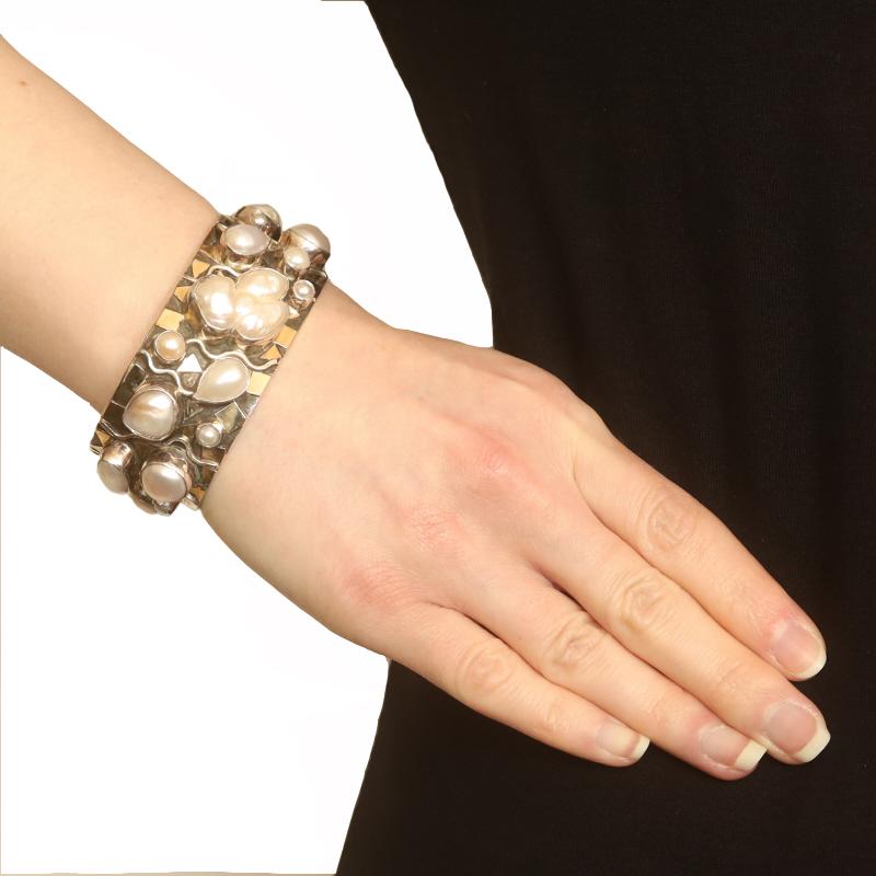 Designer: Dian Malouf

Metal Content: Sterling Silver & 14k Yellow Gold

Stone Information
Cultured Pearls
Color: White

Style: Cuff
Fastening Type: N/A (slides over wrist)

Measurements
Inner circumference (including the opening): 6 1/2