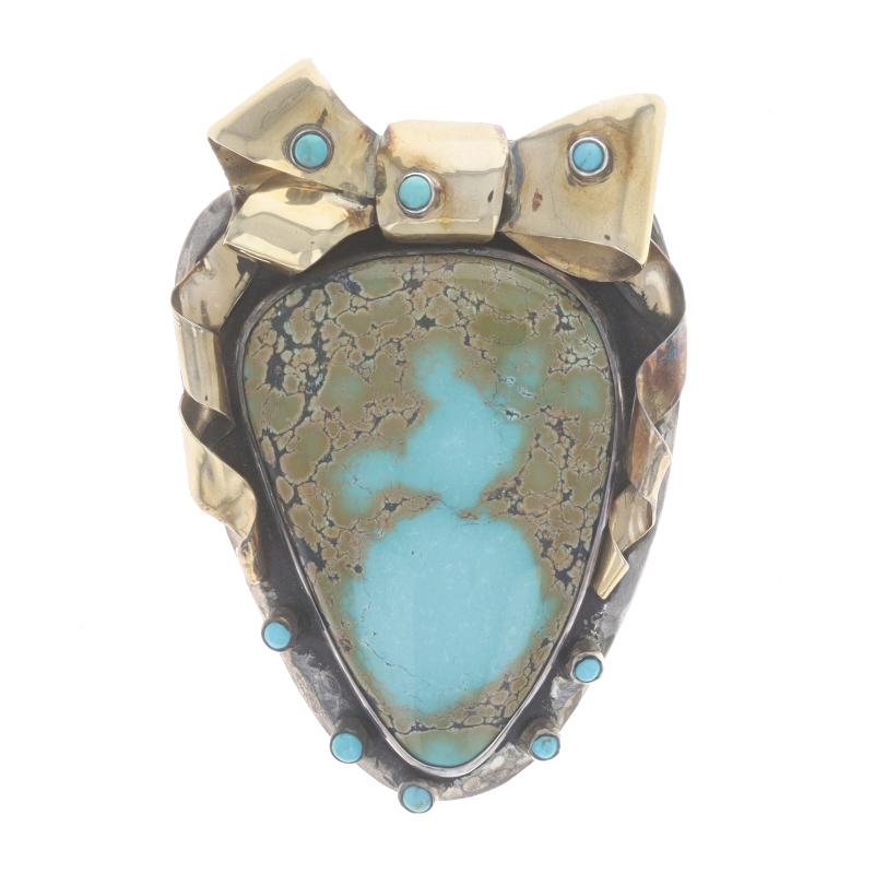 Designer: Dian Malouf

Metal Content: Sterling Silver & 14k Yellow Gold

Stone Information
Natural Turquoise
Treatment: Routinely Enhanced
Color: Bluish Green, Tan, & Brown

Style: Convertible Brooch/Pendant Enhancer
Fastening Type: Hinged Pin and