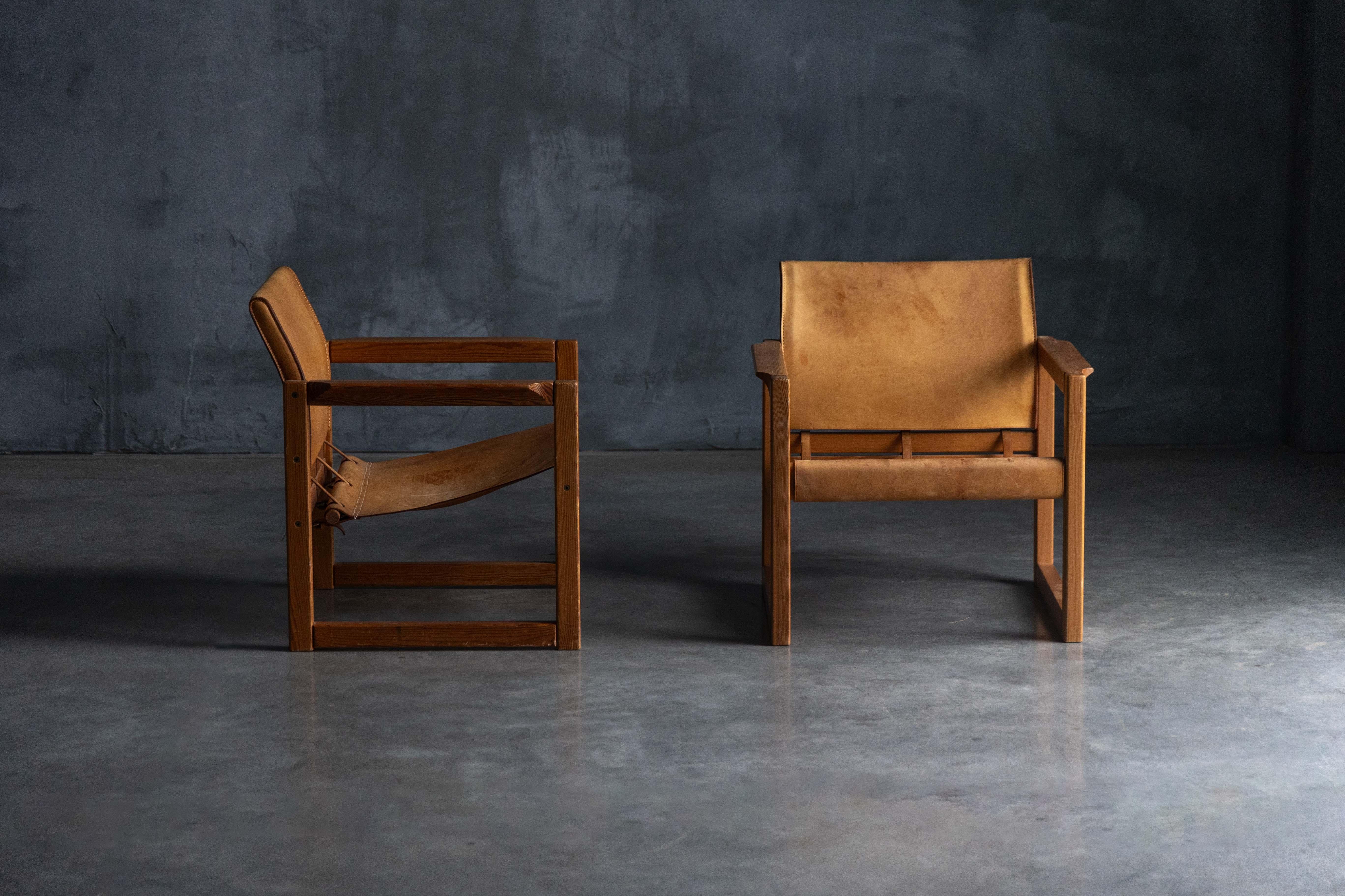 Experience timeless Scandinavian design with the Safari Diana Armchairs by Karin Mobring for IKEA, crafted in the 1970s. These iconic chairs feature rich, patinated leather that exudes vintage charm, supported by sturdy wooden frames. The Diana