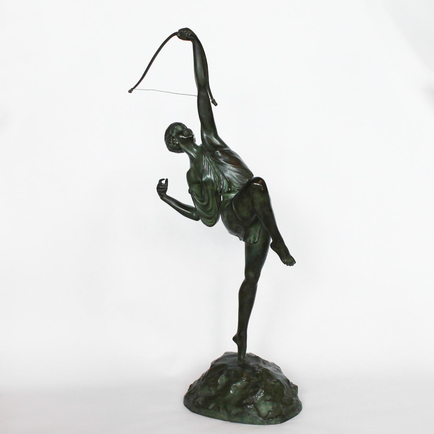 Diana, an Art Deco verdigris patinated bronze sculpture depicting Diana the Huntress. Shown in stylised pose, holding a bow aloft. 

Signed Le Faguays to cast, and inscribed and stamped for Susses Frères foundry.




