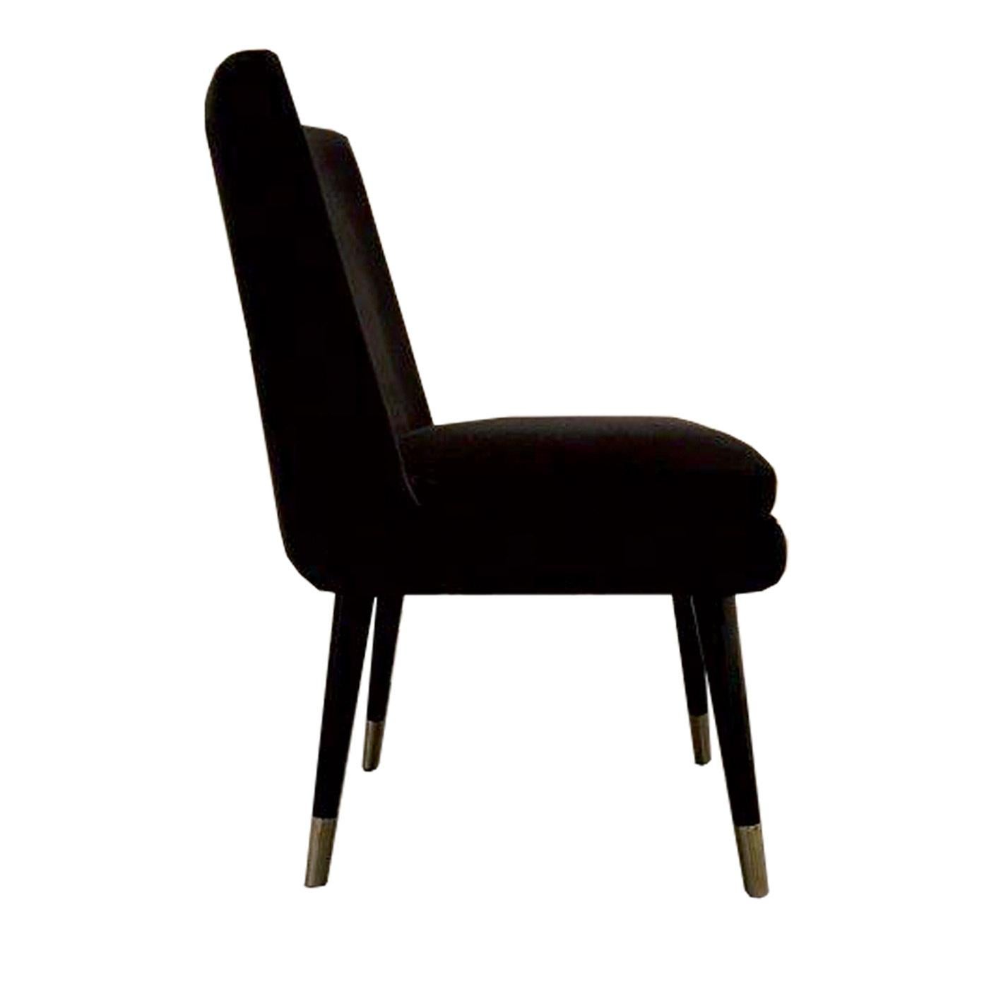 Sophisticated and inspired by the timeless grace of midcentury decor, this dining chair can also be displayed as an accent piece in an entryway or used behind a desk in the study. Its elegant and feminine silhouette is made of wood with black glossy
