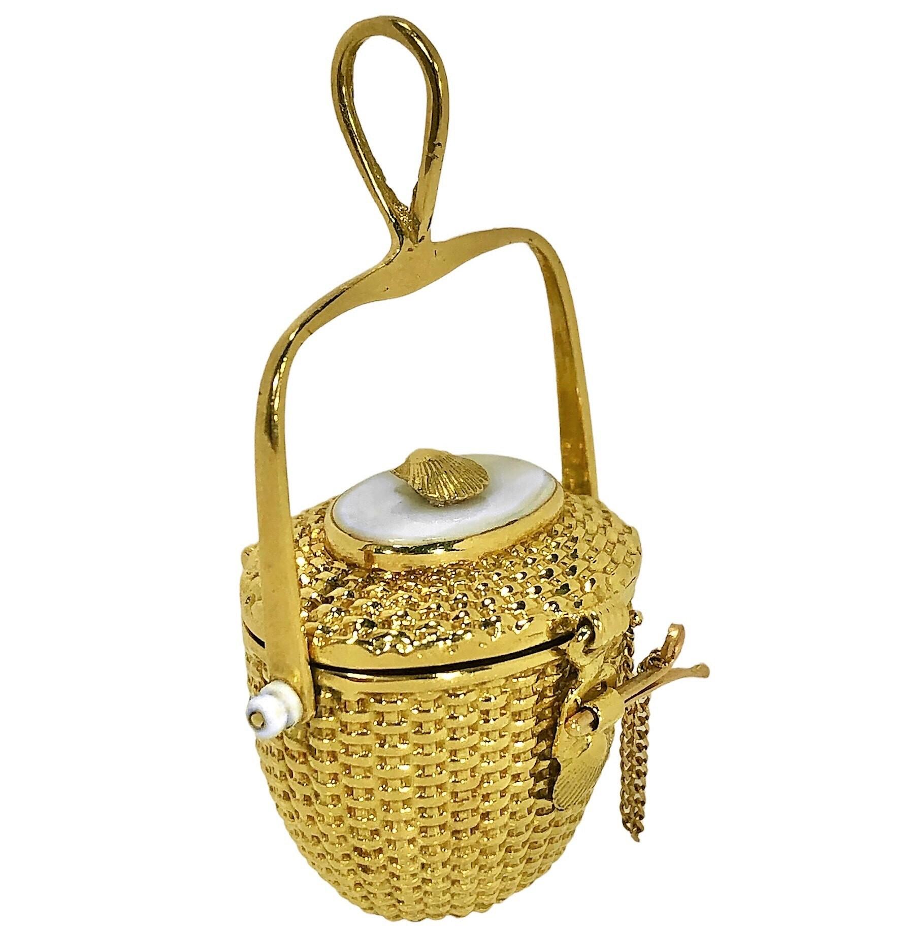 This lovely 18k Nantucket basket pendant crafted by famed jewelry artisan, Diana Kim England, is an excellent example of the beauty and loving detail that are part of all of her creations. This particular model has been retired since 1999 and