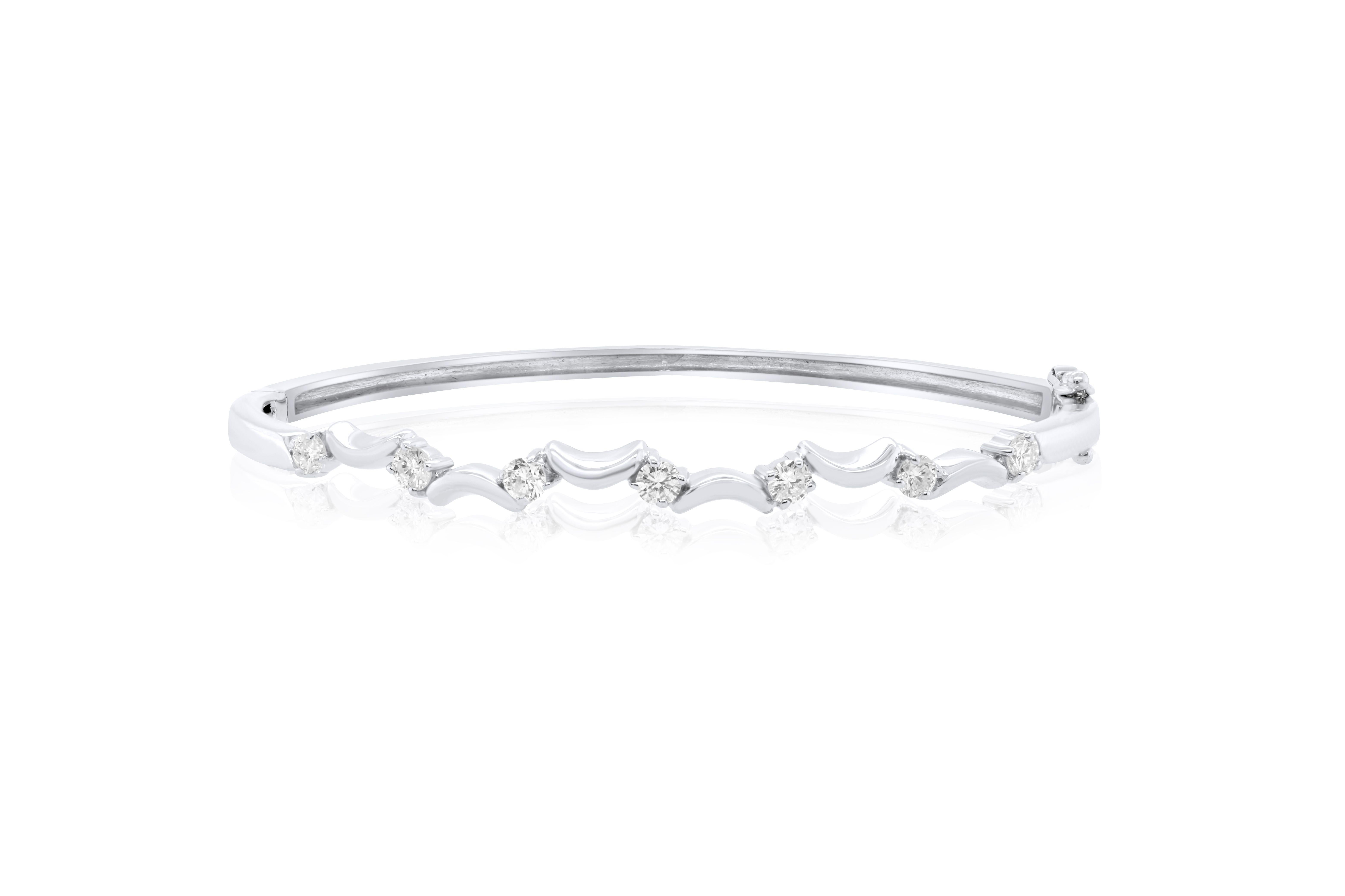 14 kt white gold bangle bracelet adorned with 0.35 cts tw of round diamonds connected with U pieces (7 stones)