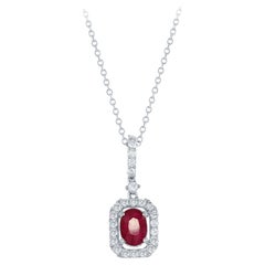 Diana M. 1.00 Carat Oval Cut Ruby and Diamond Halo Pendant