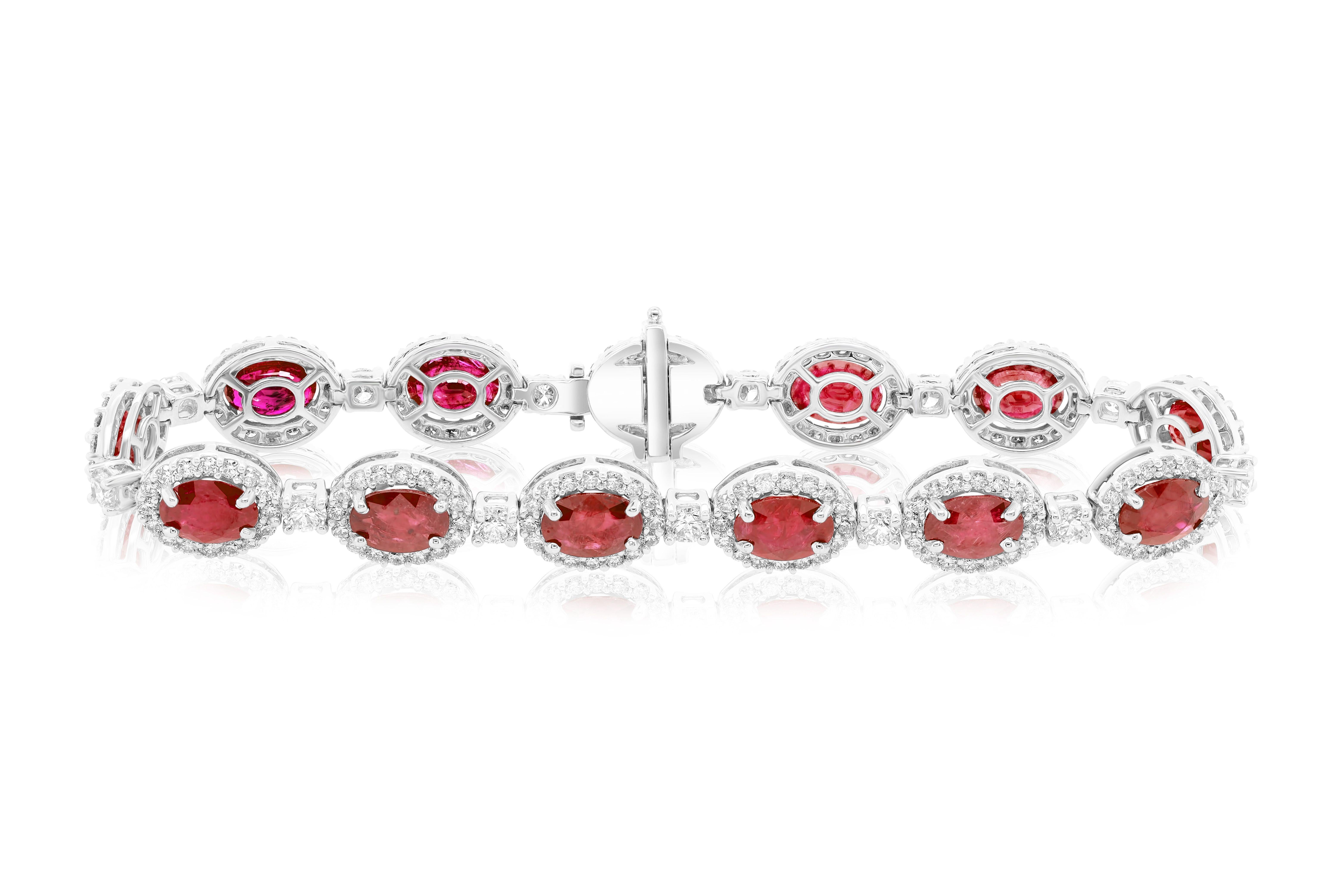 18 kt white gold bracelet adorned with 12.77 cts tw of oval cut rubies surrounded and separated by 4.08 cts tw of diamonds