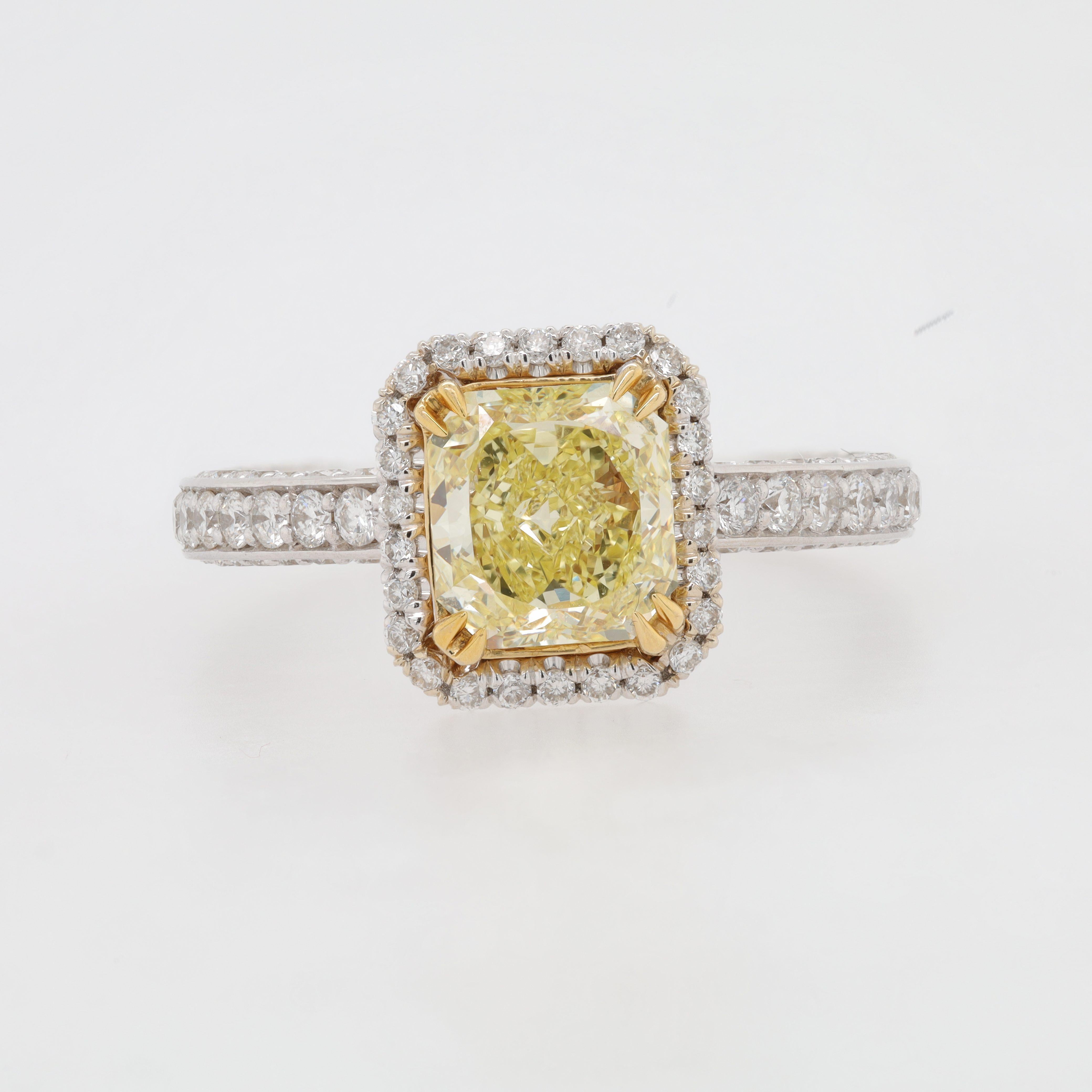 18 kt white gold engagement ring featuring a center 1.39 ct GIA certified (FIY VS2) fancy intense yellow radient  cut diamond surrounded by 1.16 cts tw of diamonds in a halo design 
Diana M. is a leading supplier of top-quality fine jewelry for over