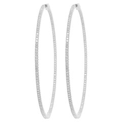 Diana M. 14kt white gold, 1.75" hoop earrings featuring 1.30cts  round diamond